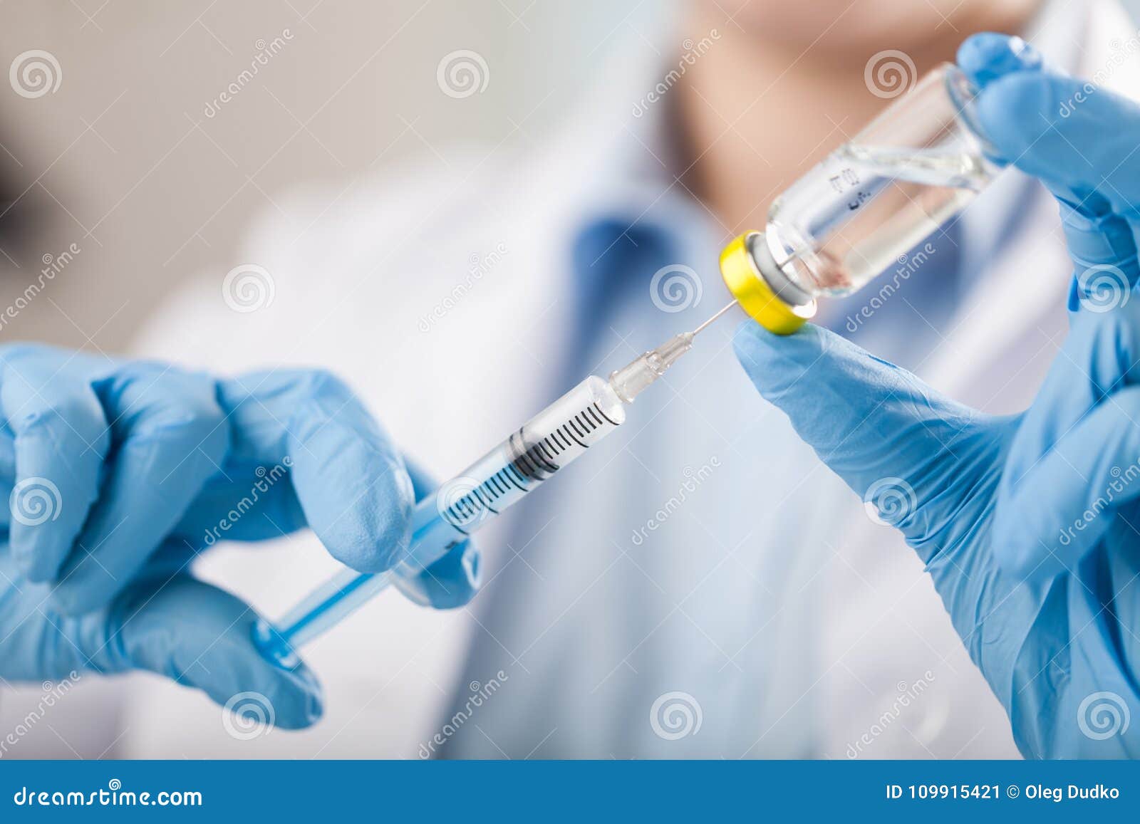 hand holding syringe and vaccine