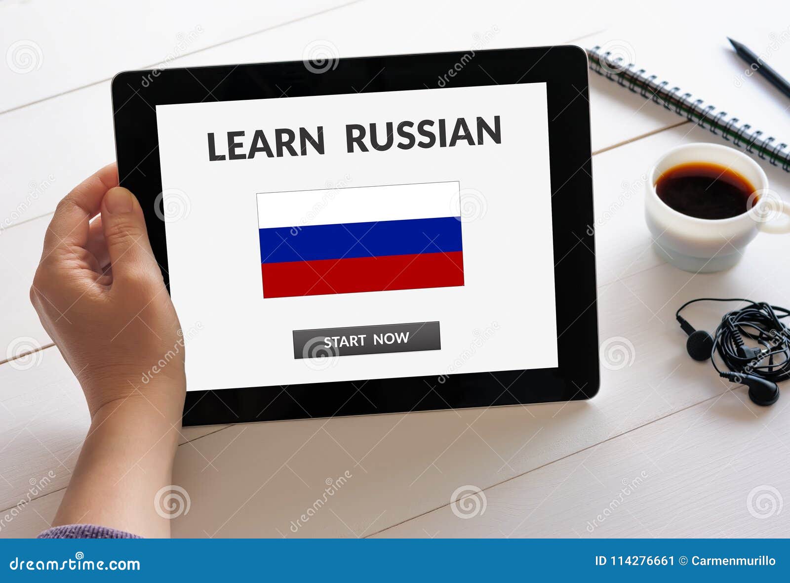 Hand Holding Tablet with Learn Russian Concept on Screen Stock Image