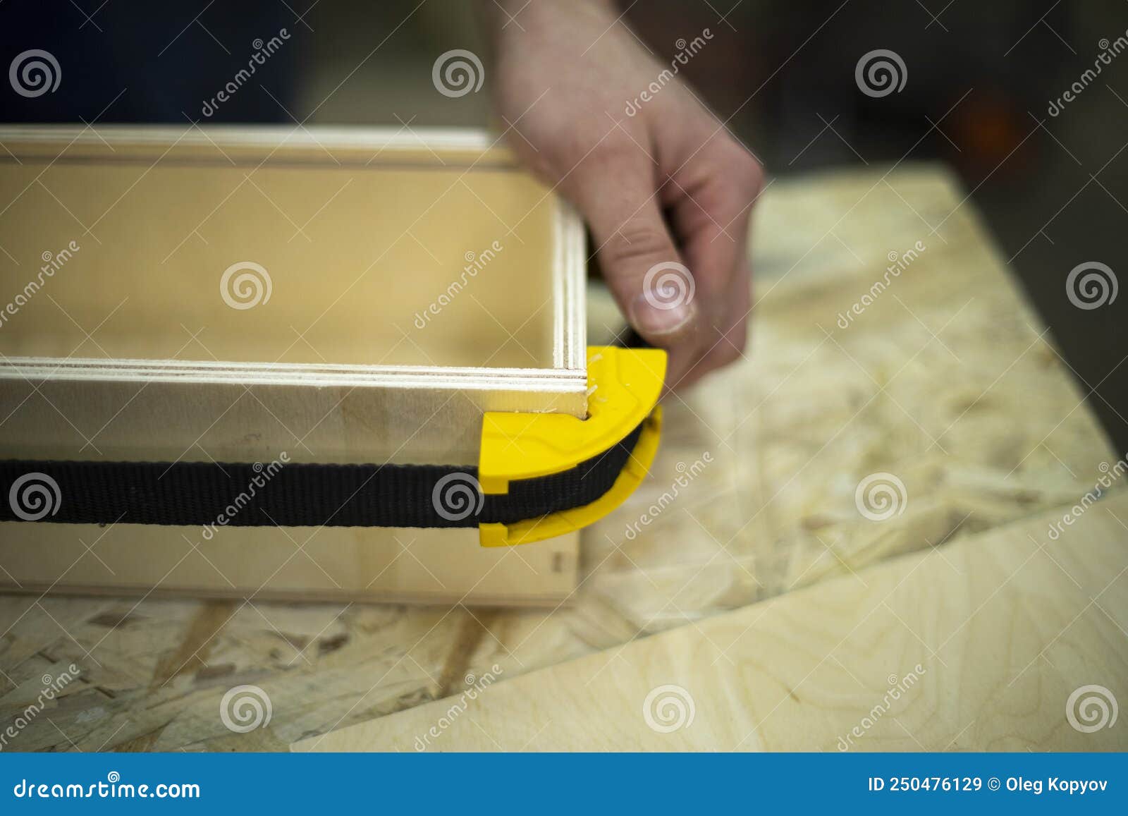 Hand Holds Box. Guy Creates Box Out of Wood. Work in Stock