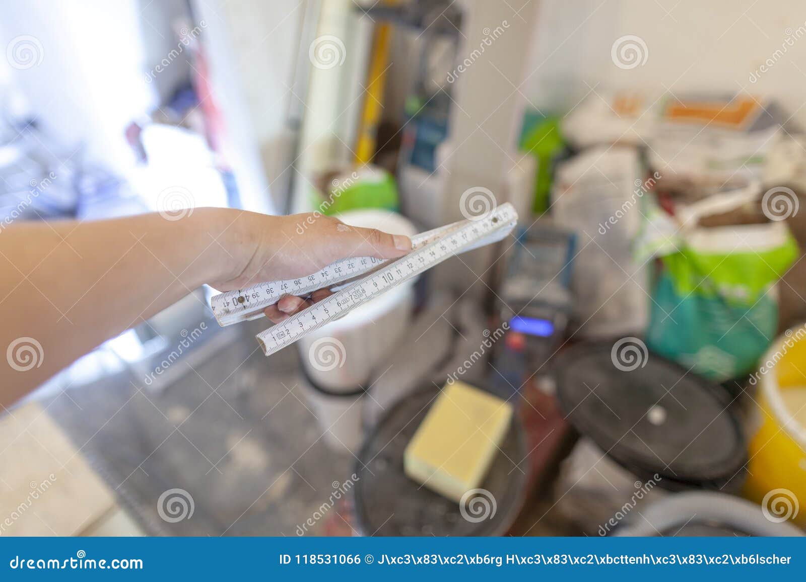 Hand Holds a German Double Meter Stick on a Construction Site Stock