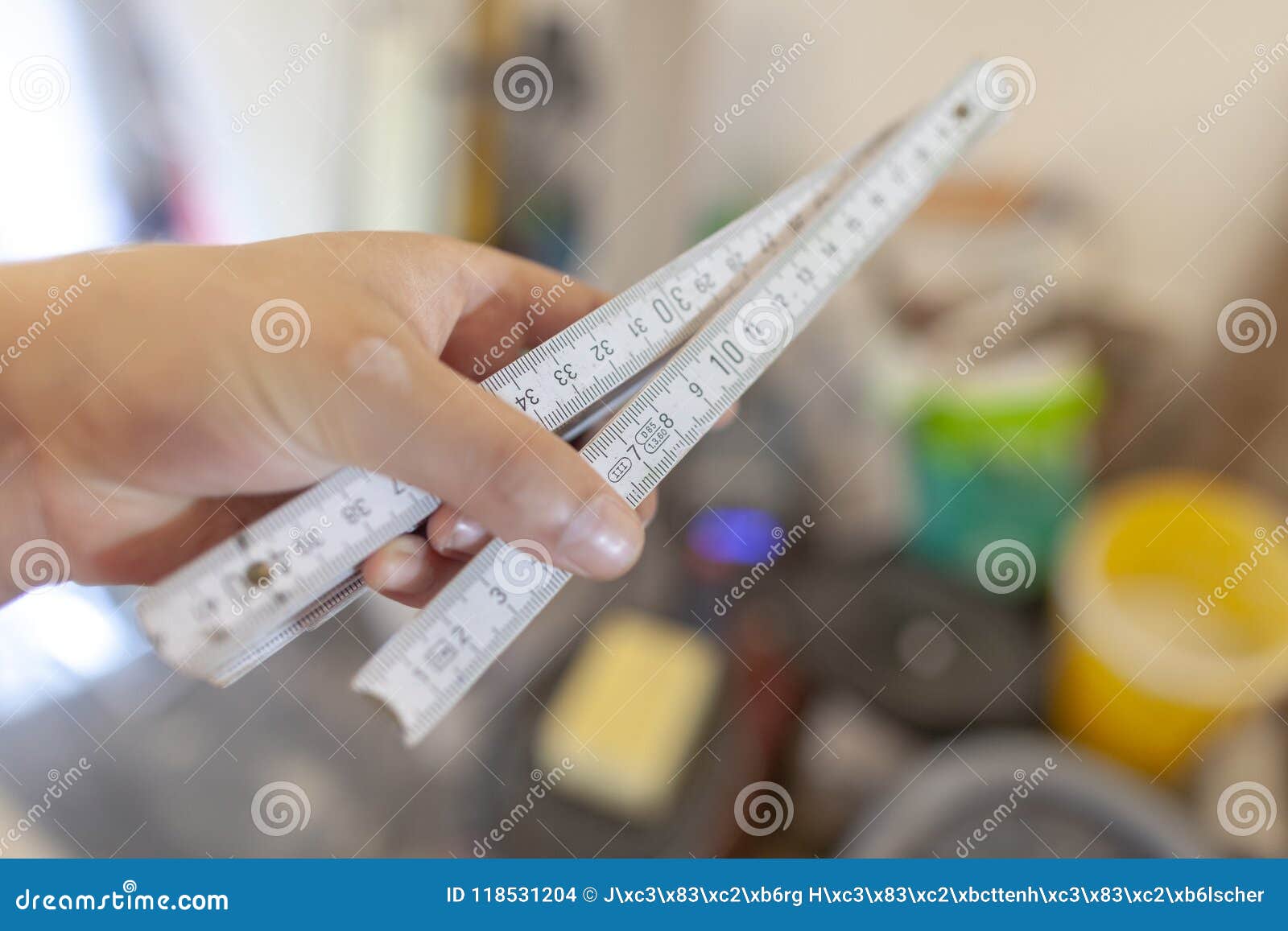 Hand Holds a German Double Meter Stick on a Construction Site Stock