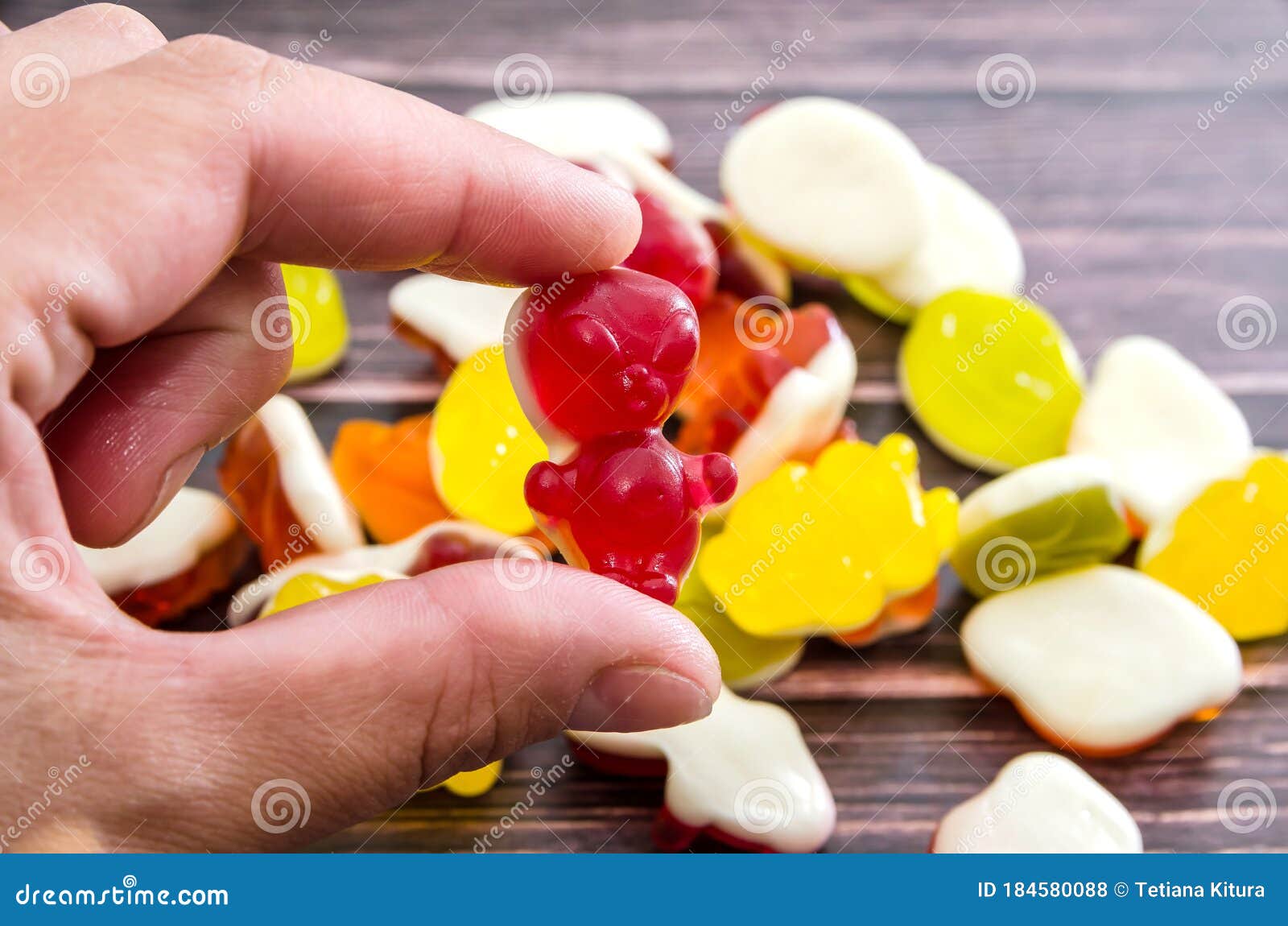 Hand Holds Jelly Candy with Fingers. Closeup. Stock Photo Image of