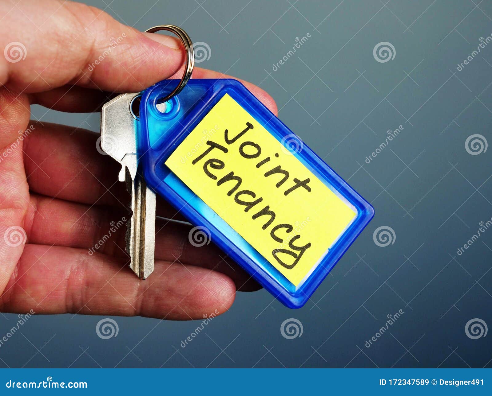 hand holds key with joint tenancy inscription