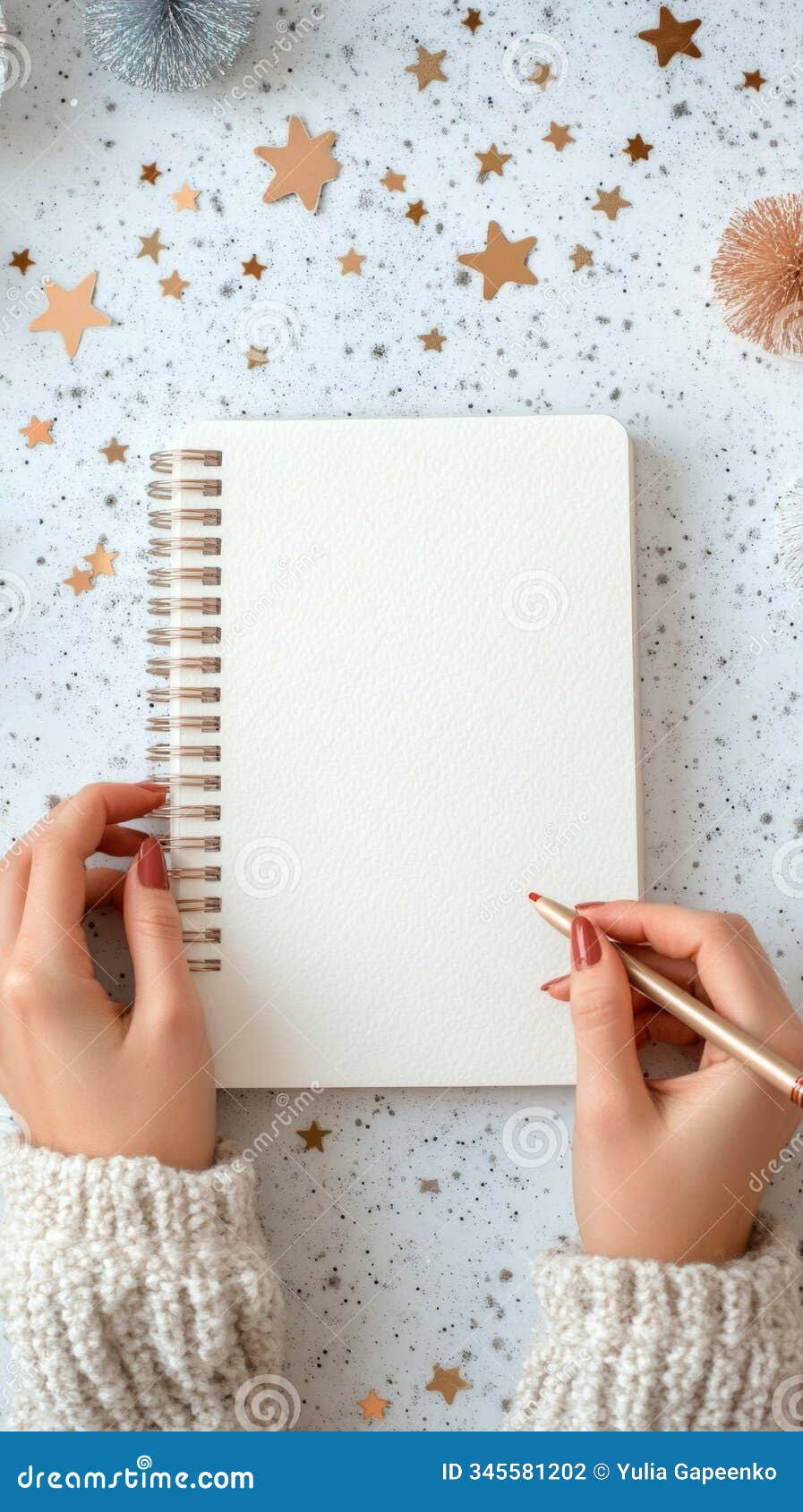 creating festive art in a cozy setting with a blank notebook and decorative stars