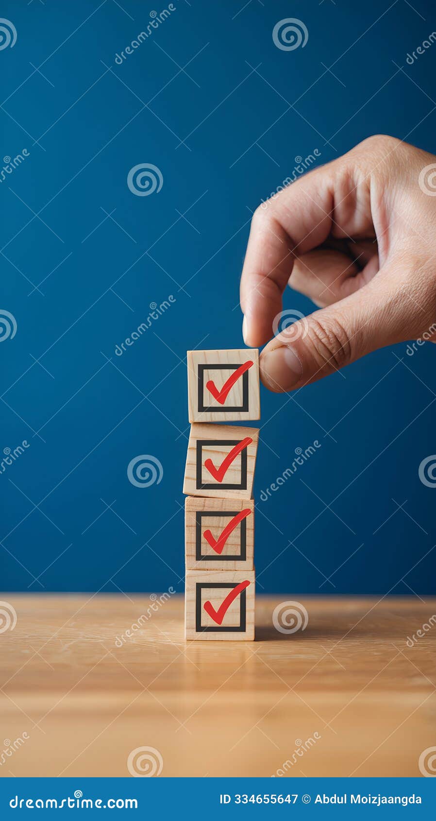 hand holds a wooden block with a red checkmark on a blue background