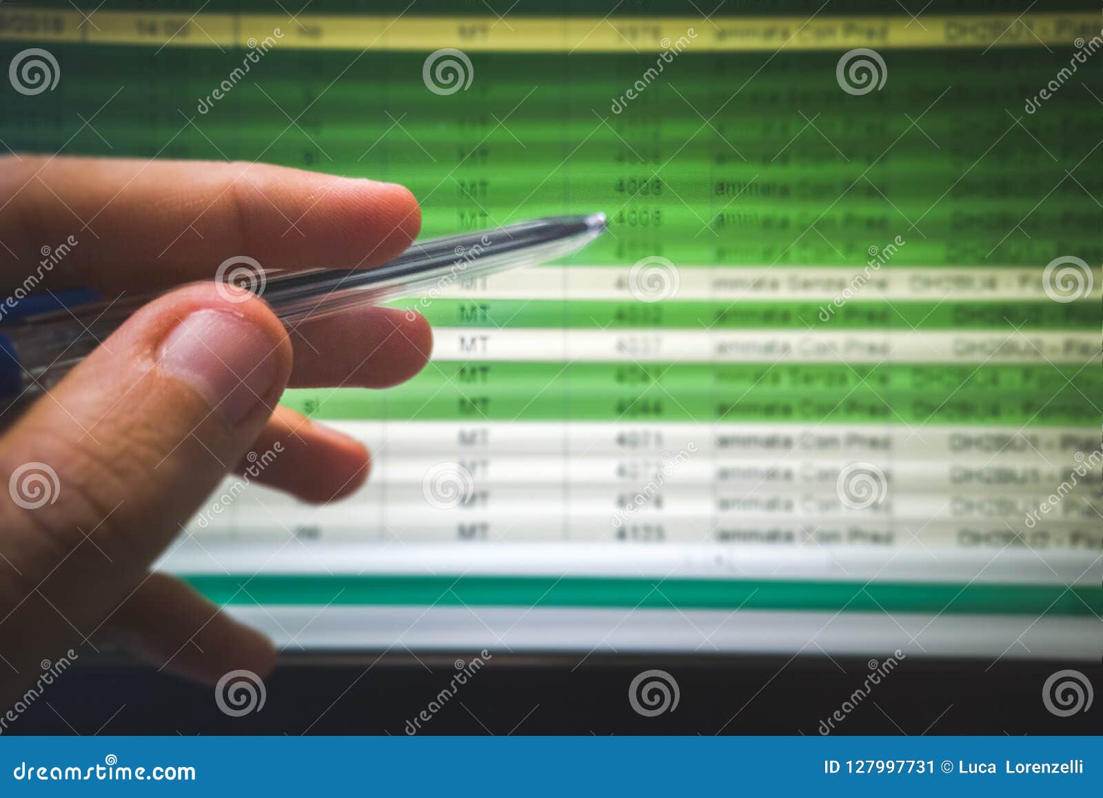 hand indicate spreadsheet on the screen with pen
