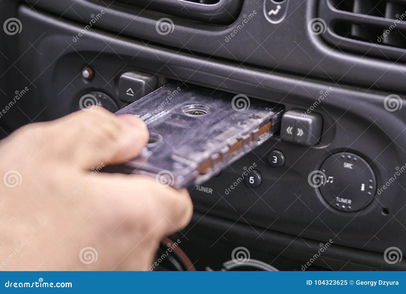 Hand Inserting a Music Cassette into Old Car Tape Player Stock Image -  Image of dial, tape: 104323625