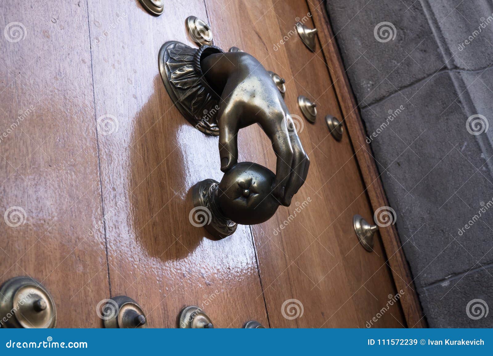 Hand knockers. Wooden door stock image. Image of doorknob 111572239