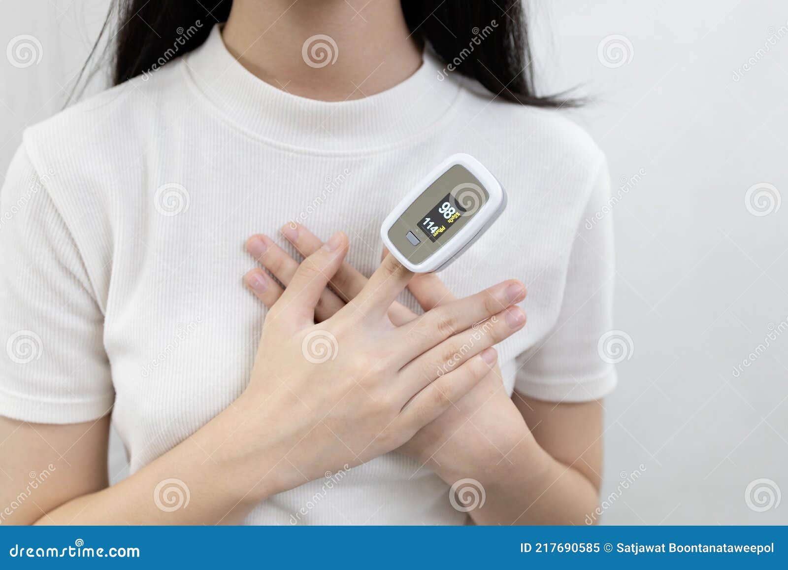 hand of lady girl with fingertip pulse oximeter on finger for examination of the lung disease,checking for coronavirus covid-19