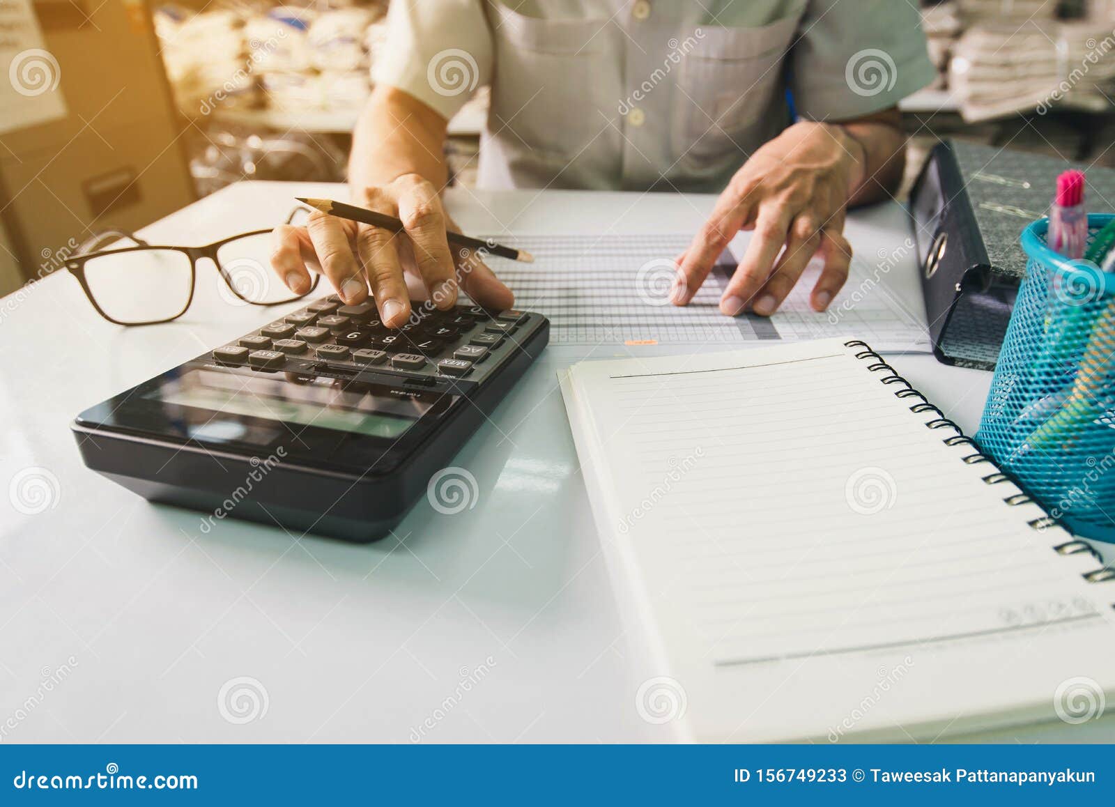 Hand Man Doing Finances and Calculate on Desk about Cost at Office