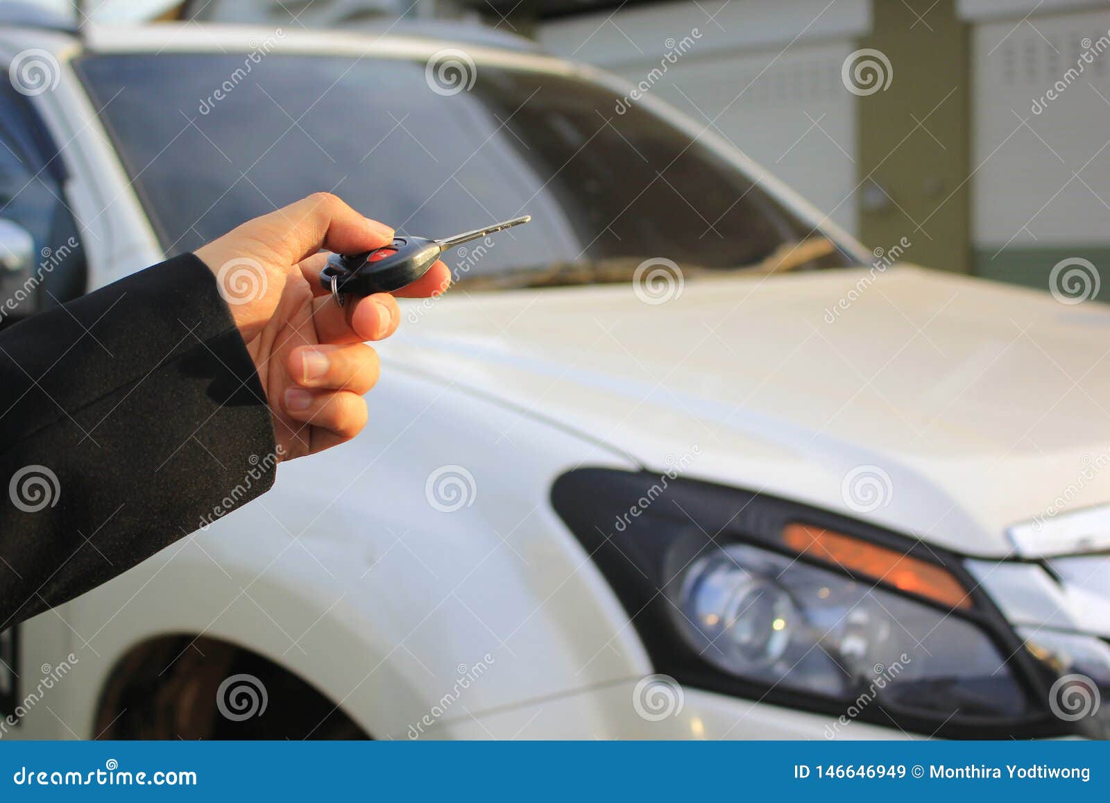 Hand Of Man Holding Car Remote Control Pointing To Car Door Open