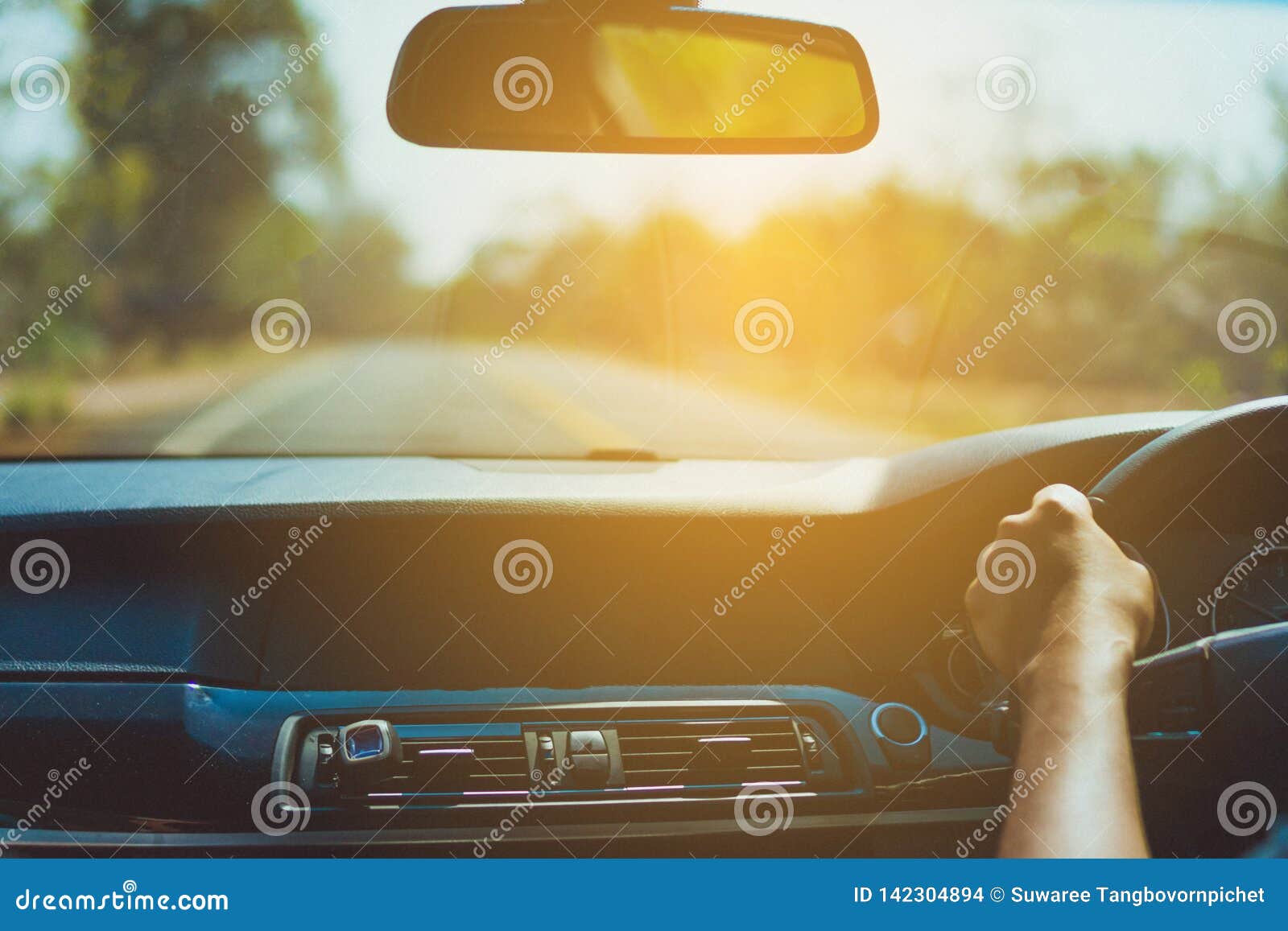 Hand of Man on Steering Wheel Drive a Car with Background Stock Photo