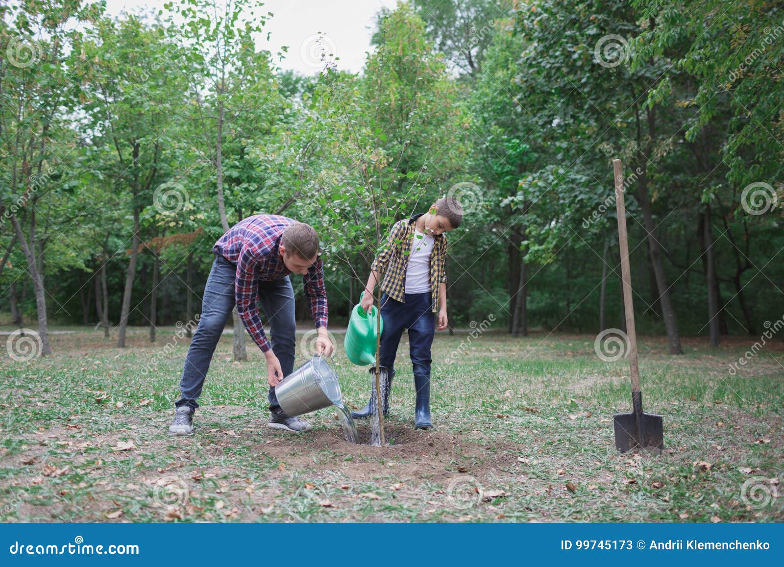 Young Growing Plant On The Human Hand With Icon Of Watering Shower