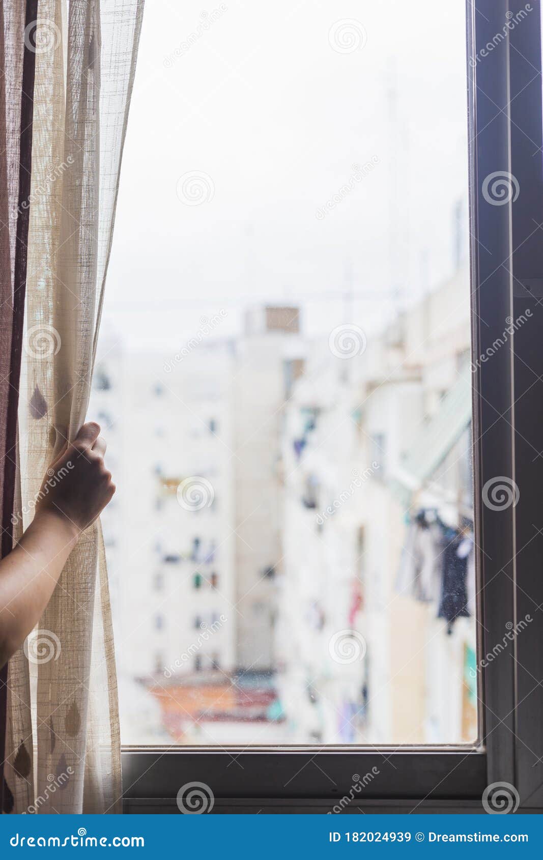 hand opening window curtain of house