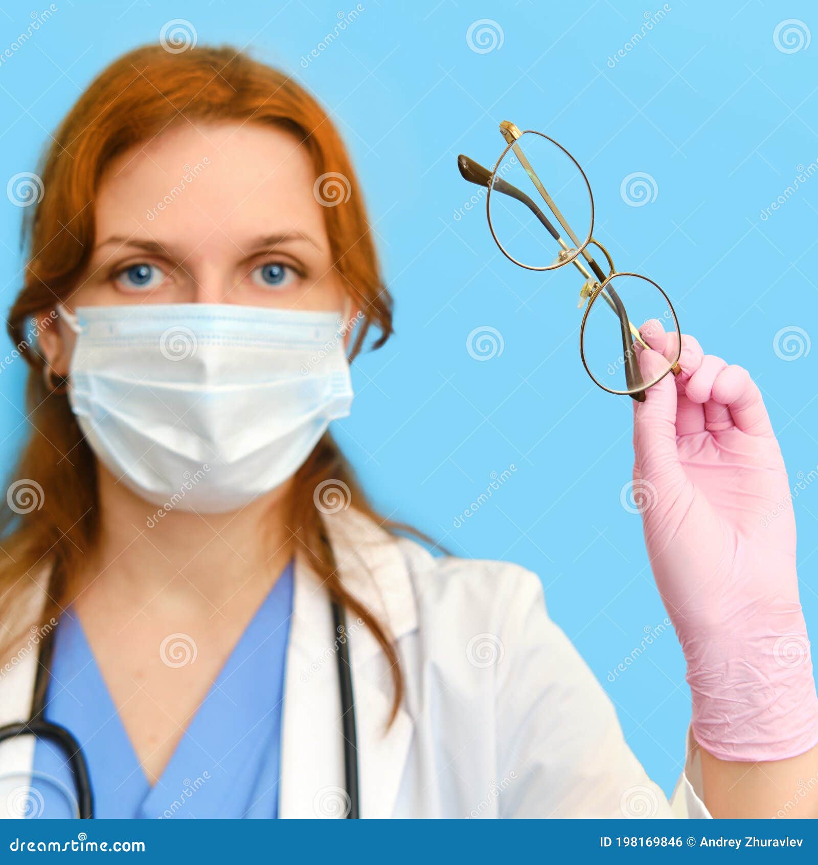Hand of an Ophthalmologist Doctor with Glasses on a Blue Background Stock Photo Image of