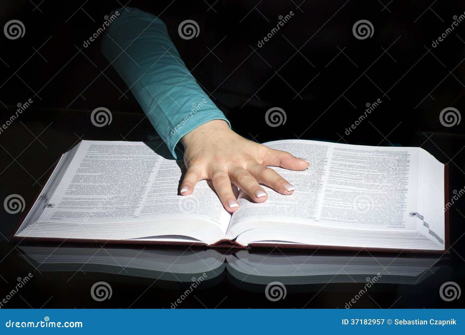 Hand on pages of open book stock image. Image of spread - 37182957
