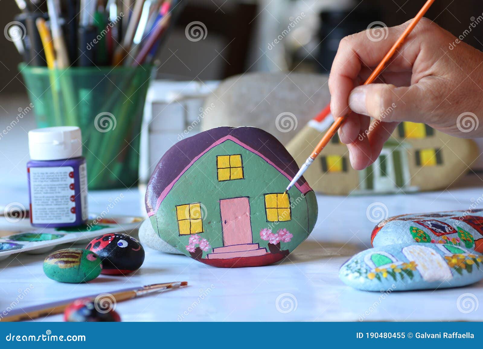 Hand Painting Stone As Home with Small Brush Stock Image Image of