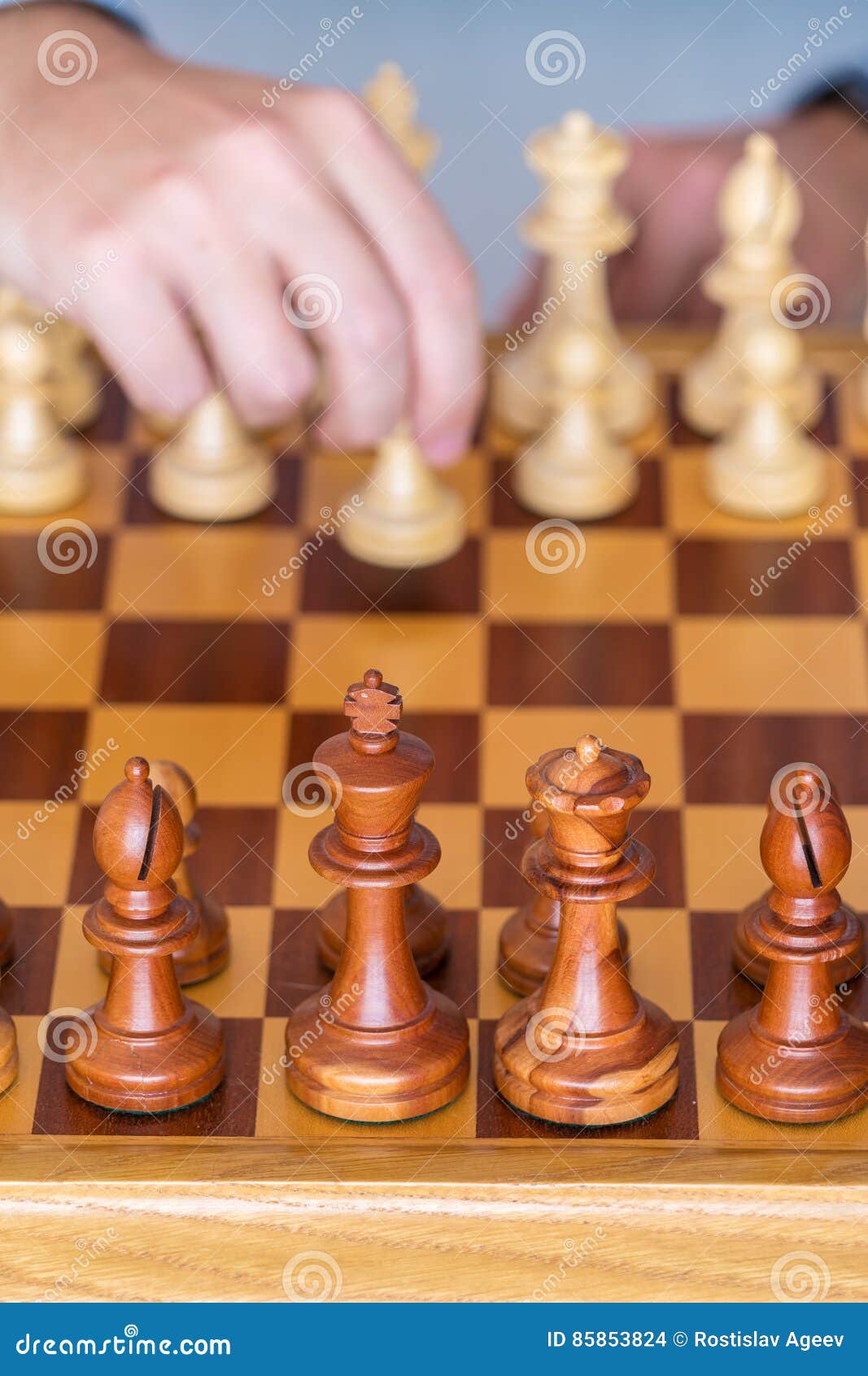 Hand Of A Man Taking A Chess Piece To Make The Next Move In A Chess Game.  Close Up. Spring Day Outside. Stock Photo, Picture and Royalty Free Image.  Image 198493640.