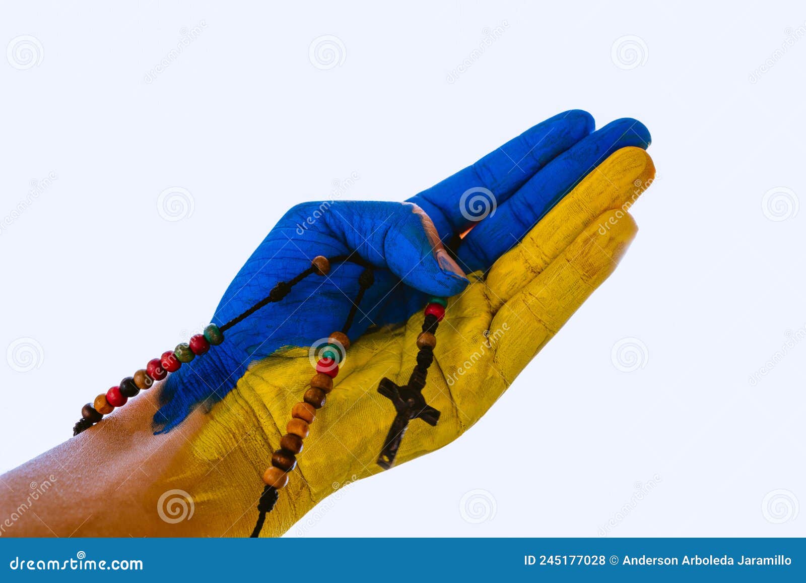person's hand painted with ukraine flag with jesus necklace