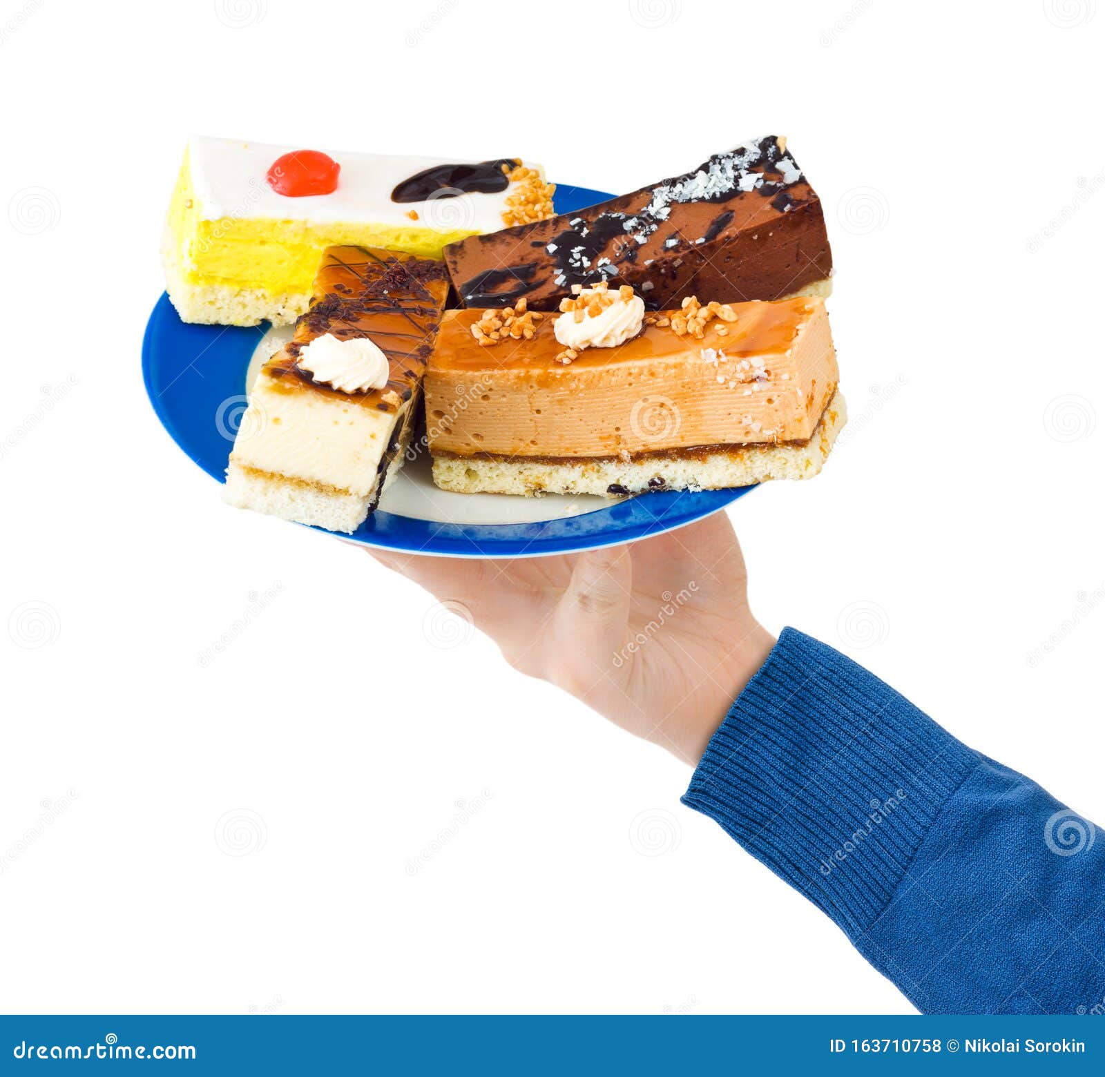 Hand and plate with cakes stock photo. Image of cakes 163710758