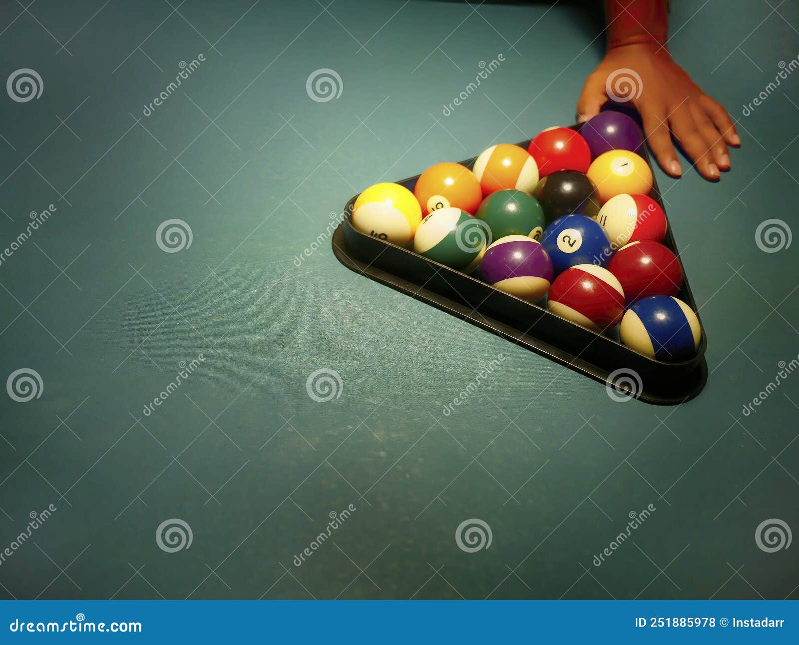 Hand Preparing Pool Balls in Triangle Rack on the Billiard Table with