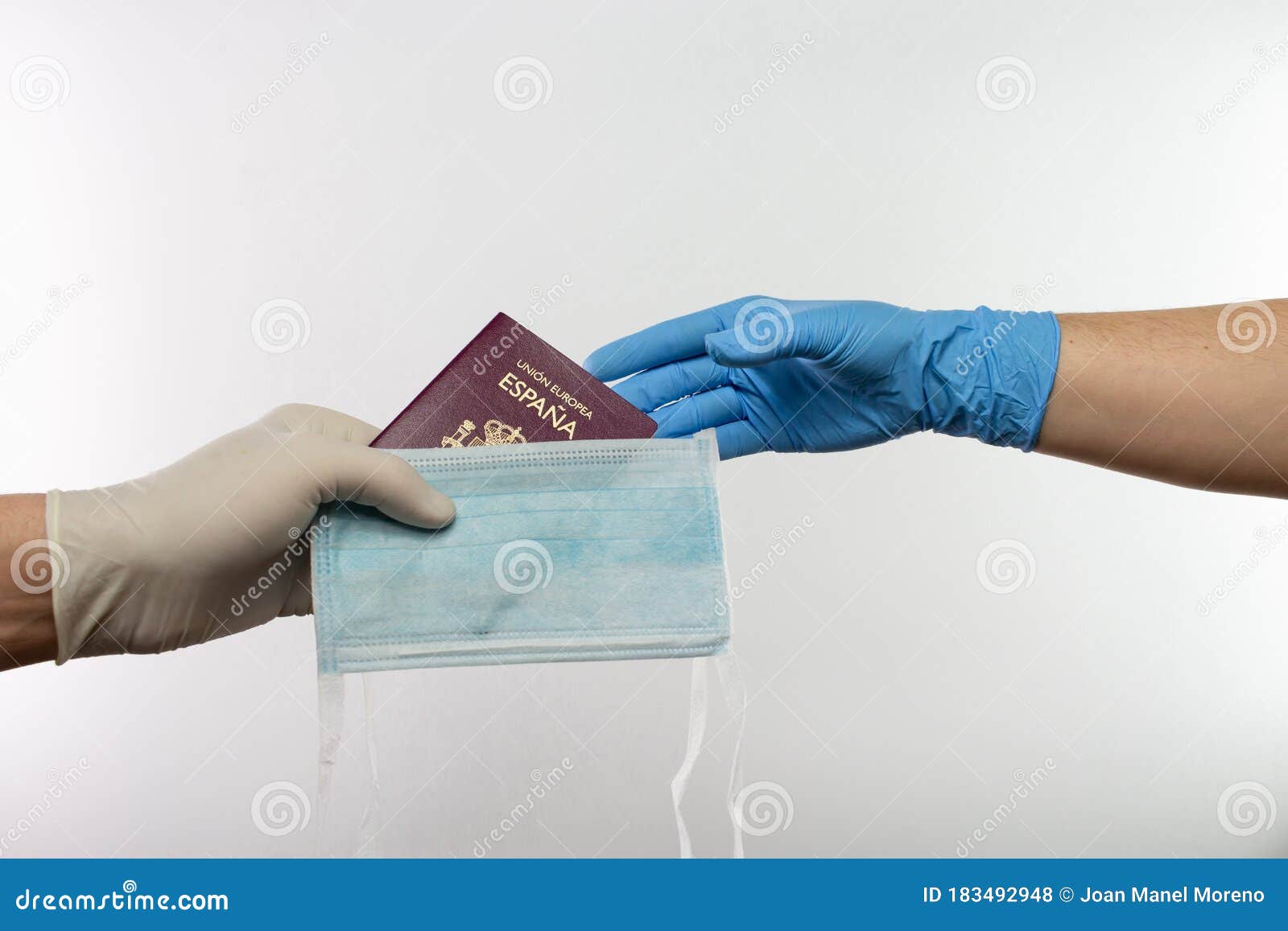 Hand With Protective Gloves Giving A Spanish Passport With