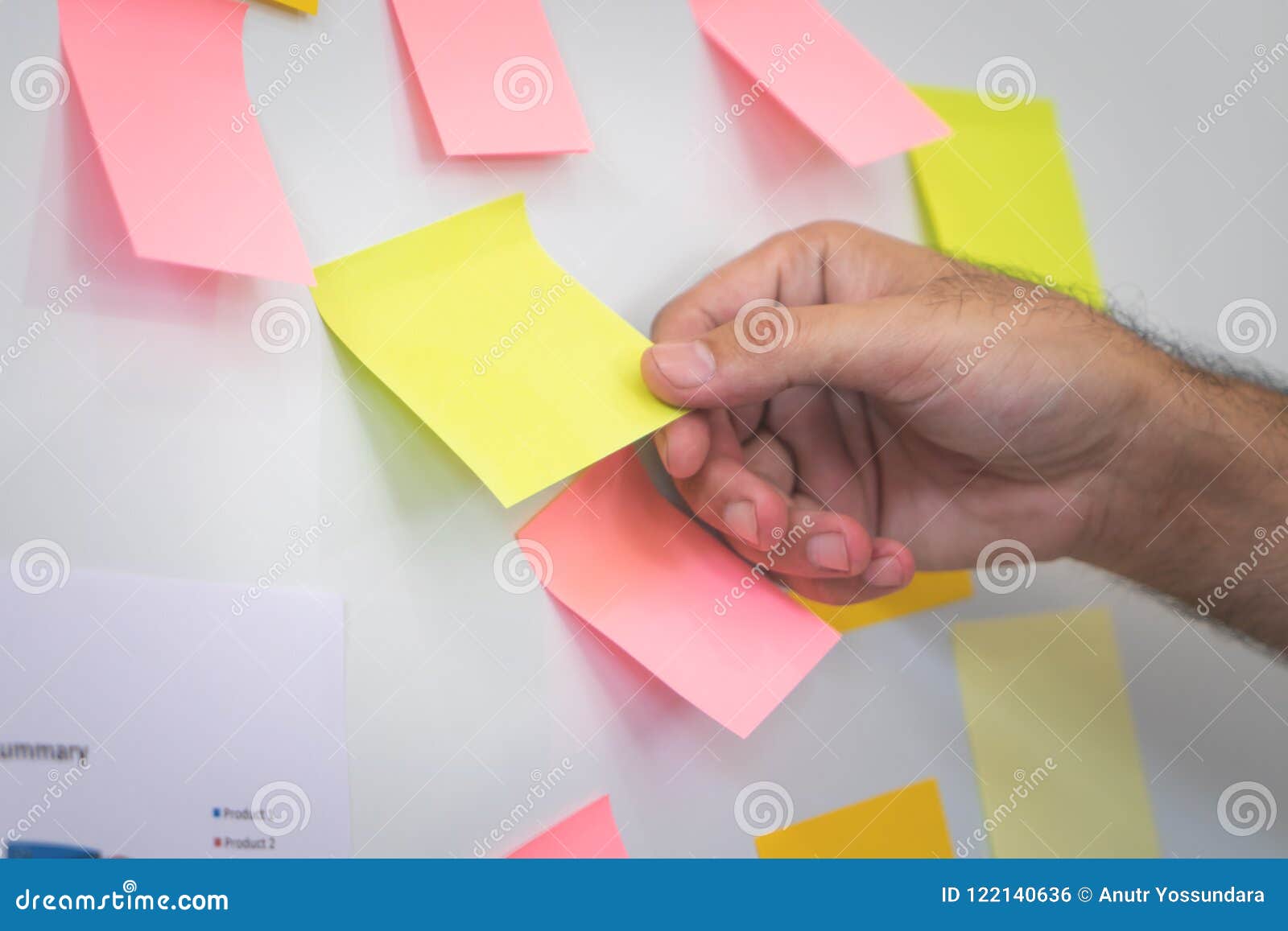 Pulling Reminder Posted Note Paper Out of the Board Stock Photo Image