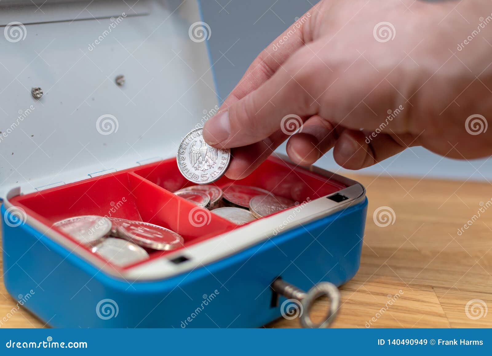 Hand Puts a Coin in a Blue Cash Box Stock Image Image of deposit
