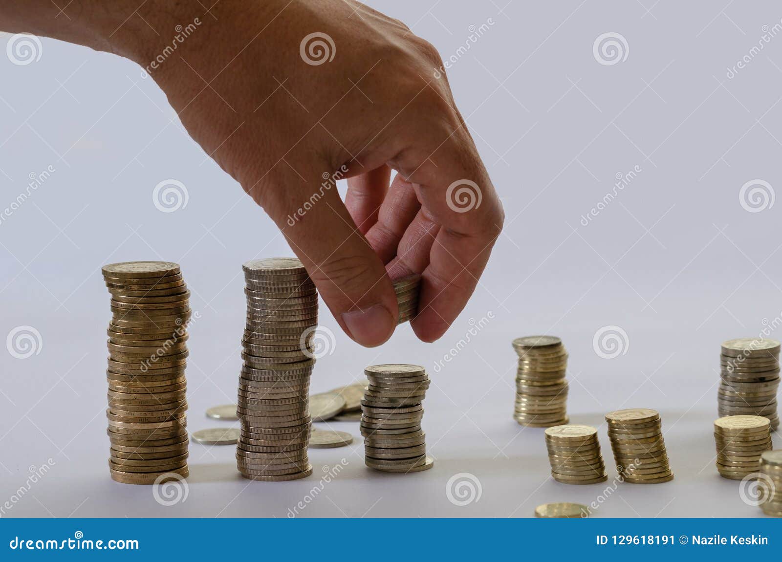 Hand Putting Money Coins Stack Growing, Saving Money for Purpose Stock