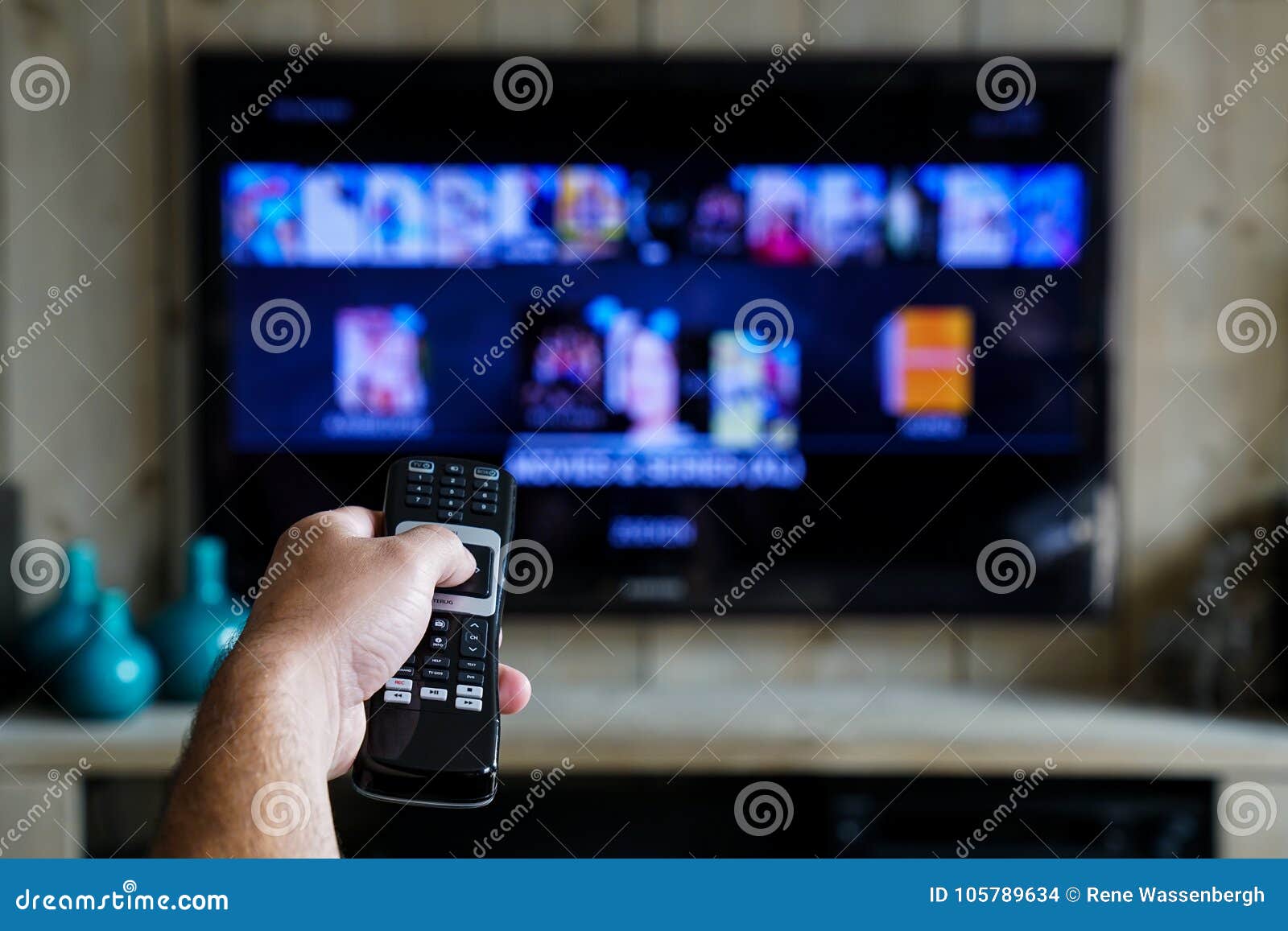 hand with a remote control. whats on tv, sliding through apps en movies on your television