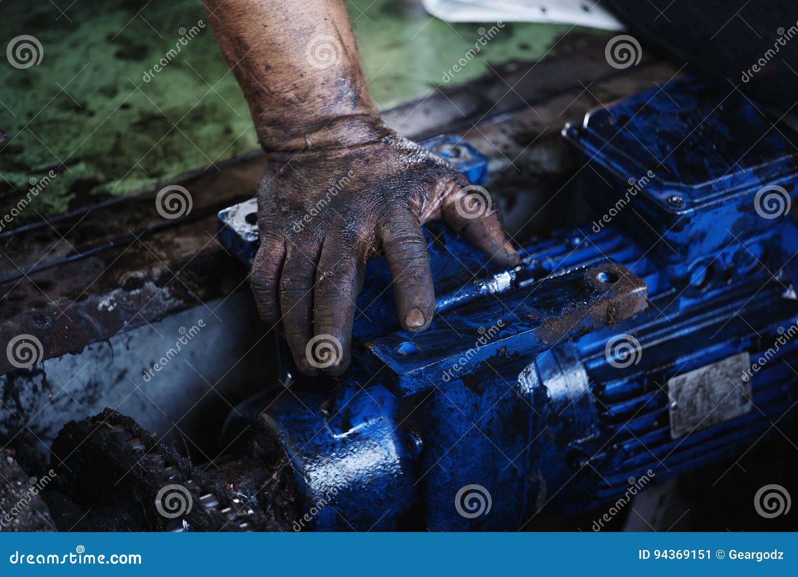 Hand of Repairman during Maintenance Work of Electric Motor Stock Image