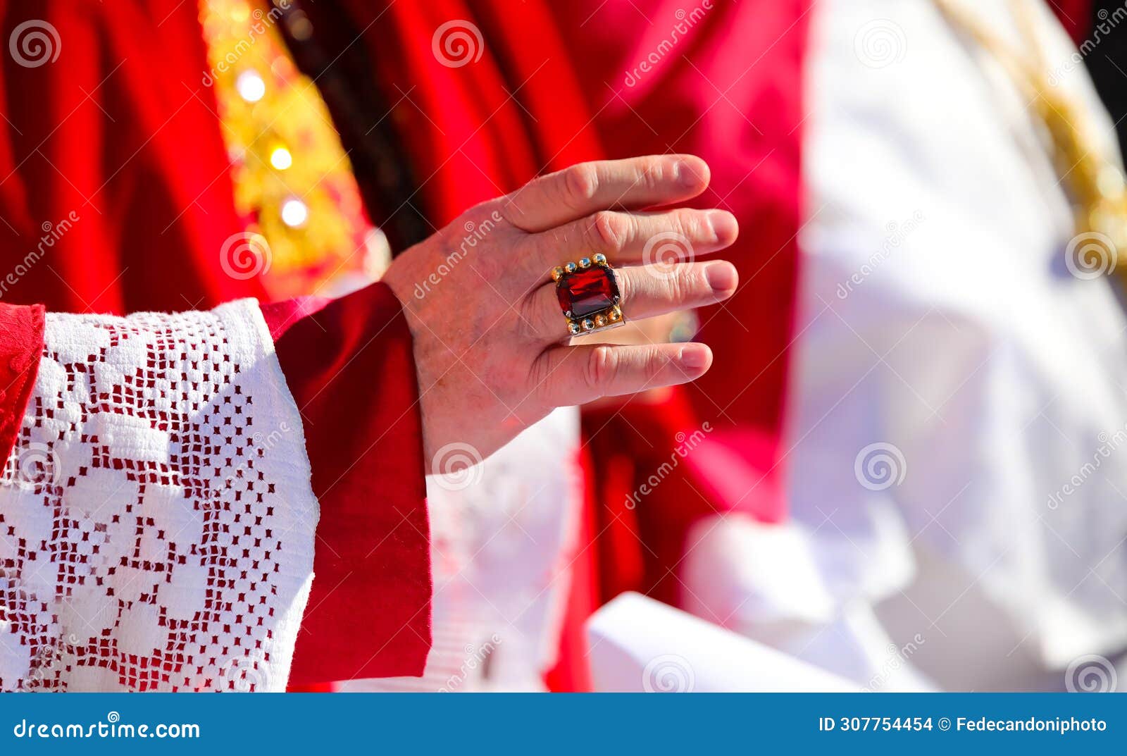 hand with ring of the red-clad cardinal during the blessing of the faithful