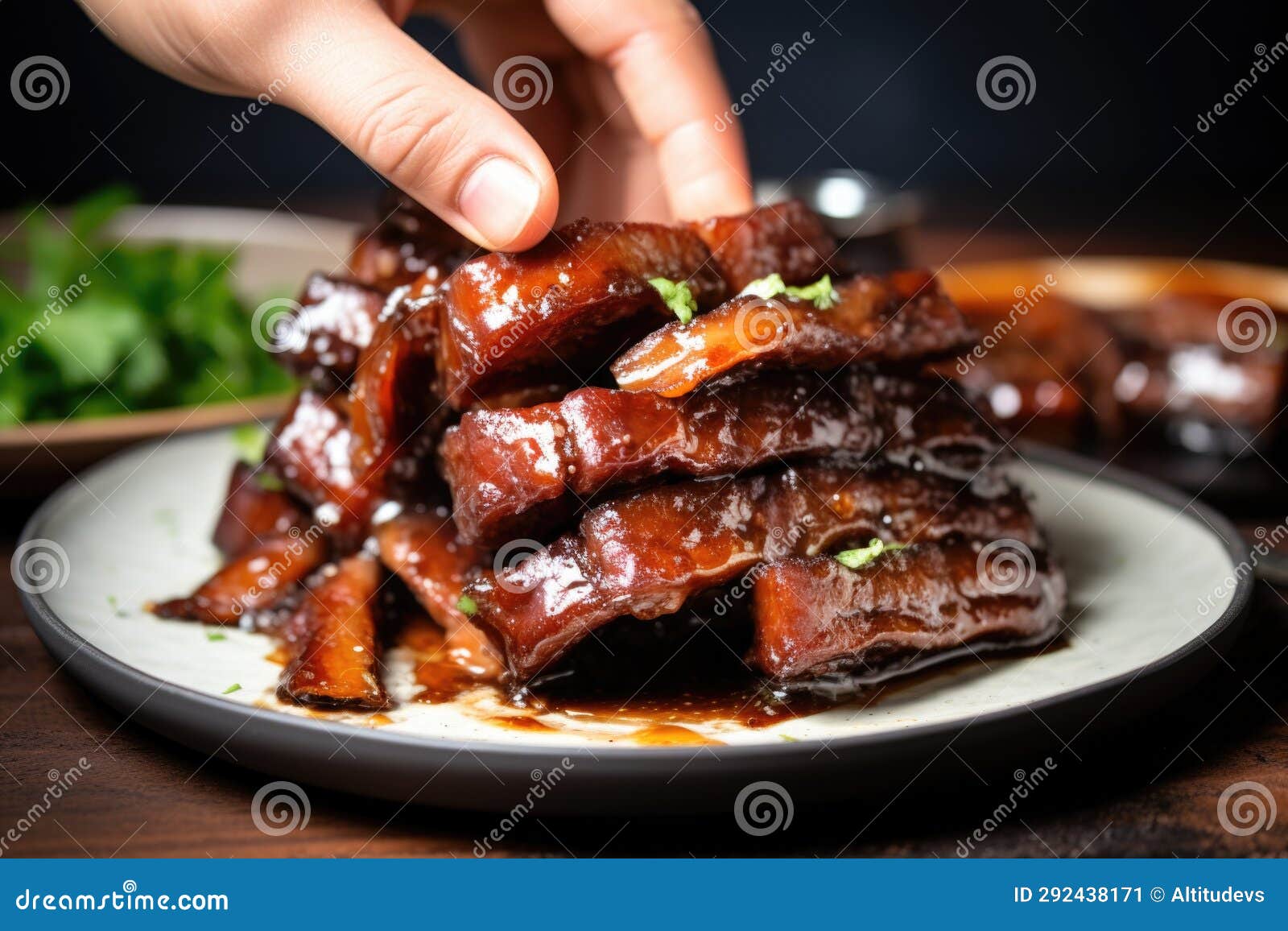 Hand Serving Glazed Pork Ribs on a Plate Stock Image Image of serving
