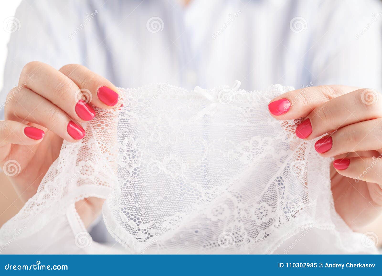 Female Hands Holding Black and White Lacy Panties, White