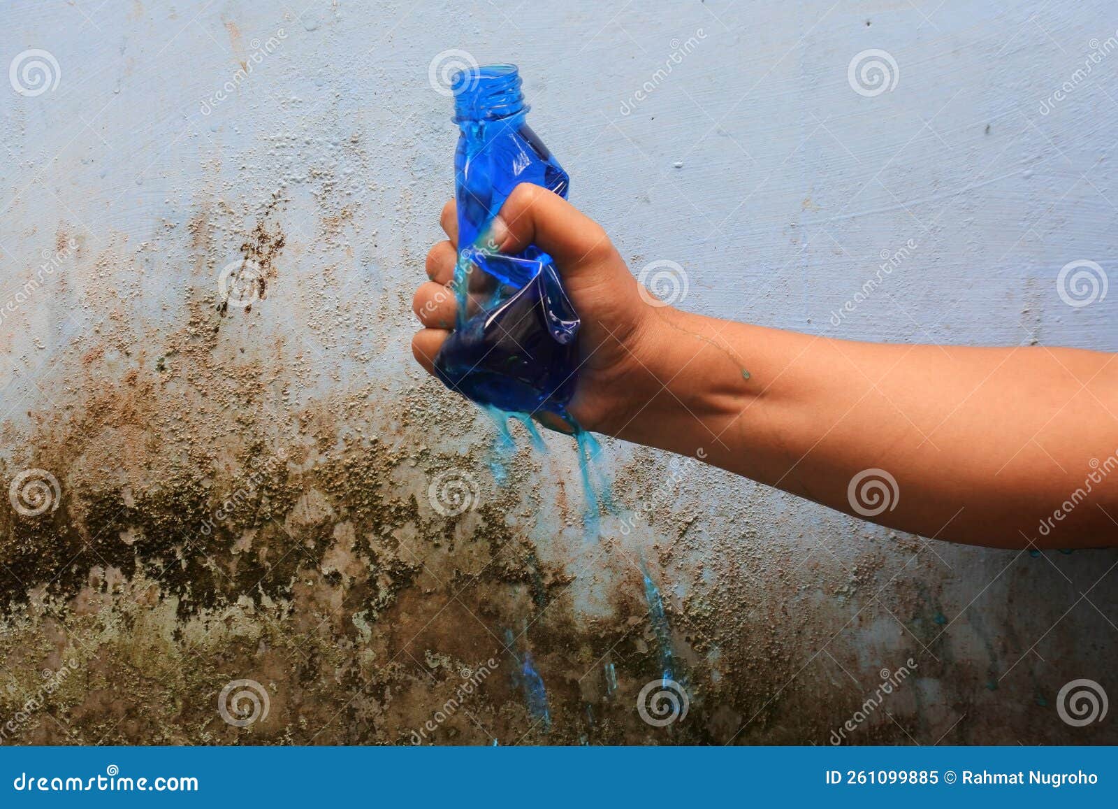 Hand Squeeze the Bottle Filled with Liquid until it Spurts Stock Image