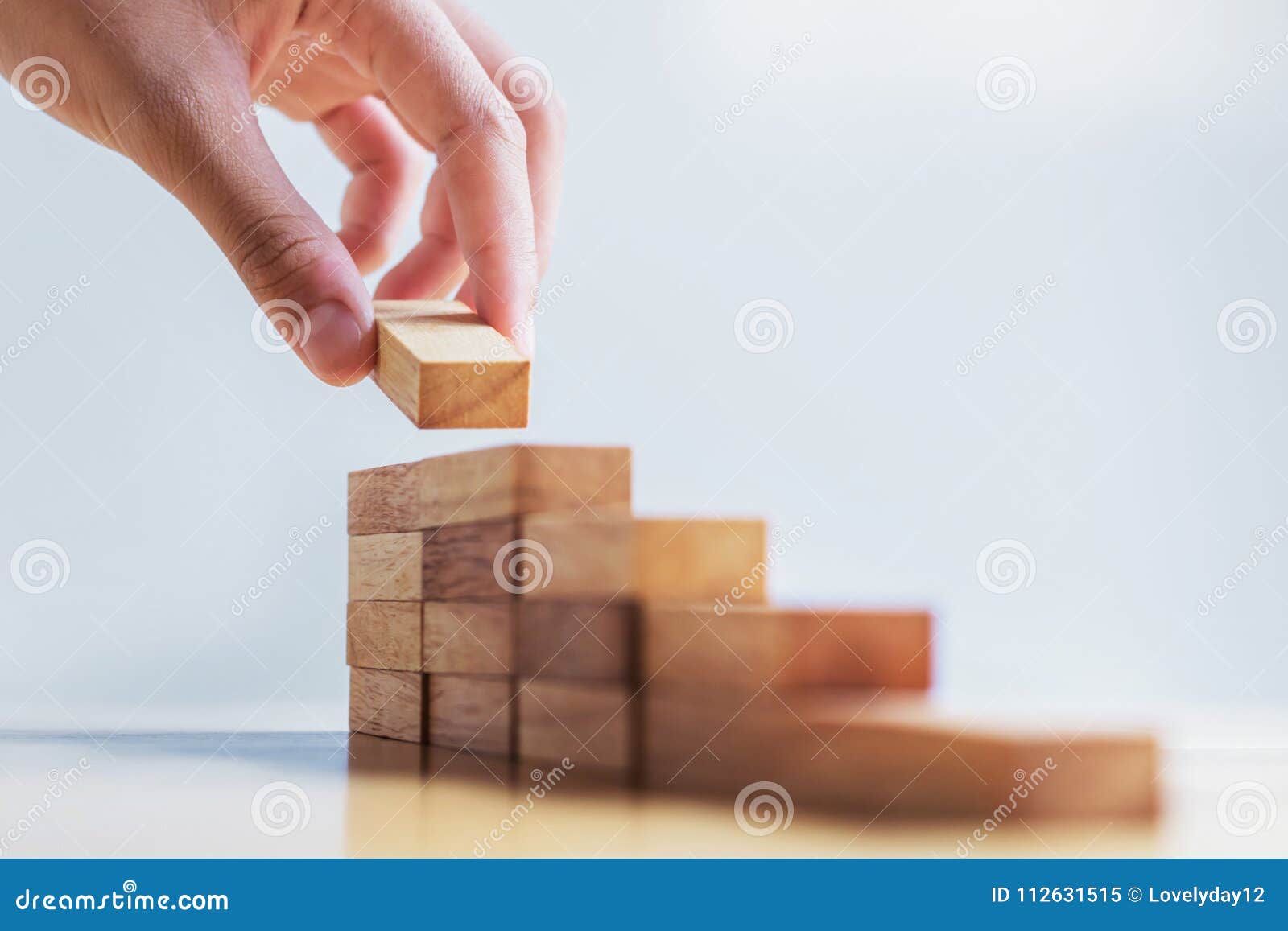 hand stack woods block step on table. business development concept