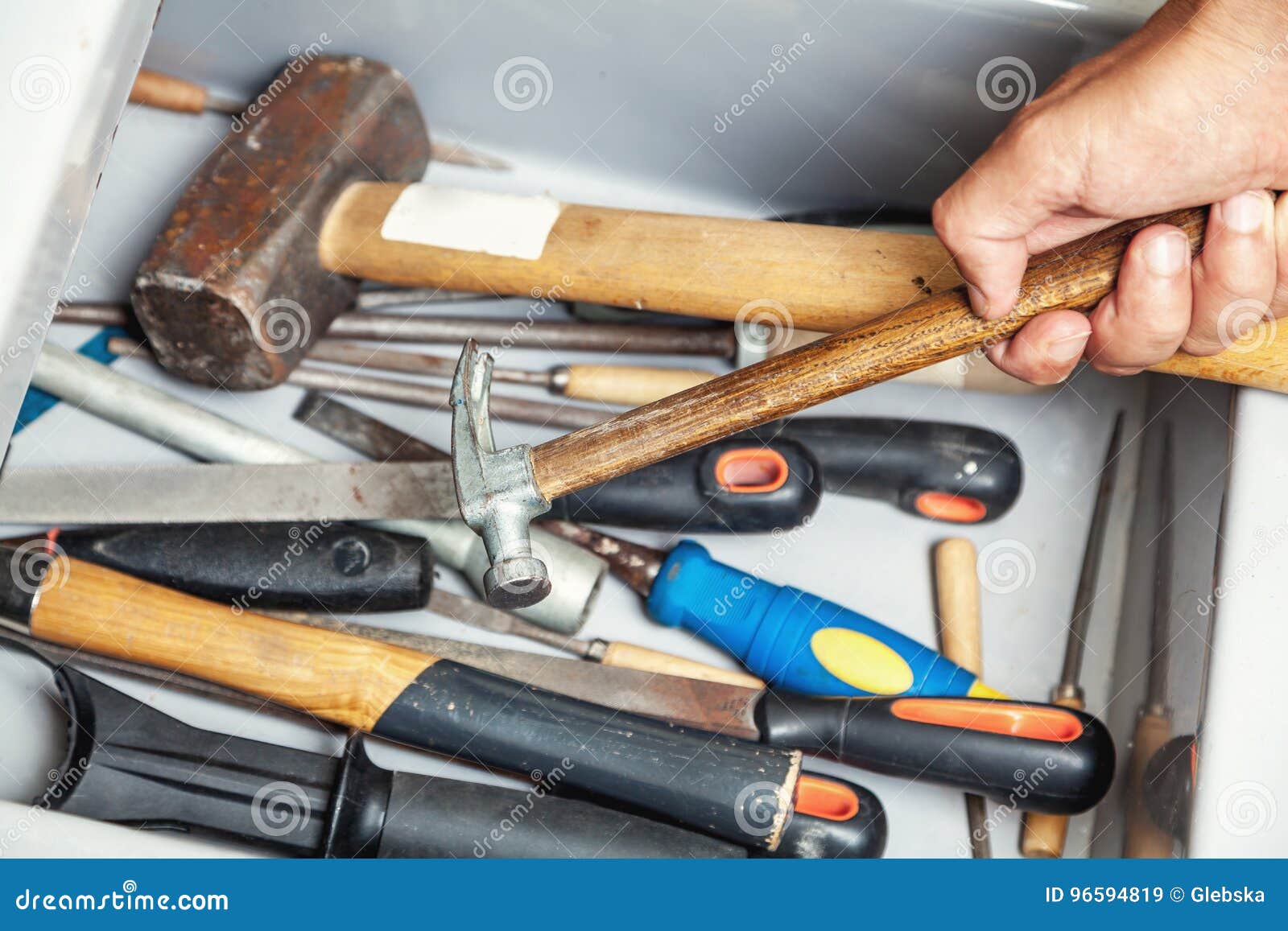 Hand Takes Hammer from Metal Box with Different Tool Stock Image