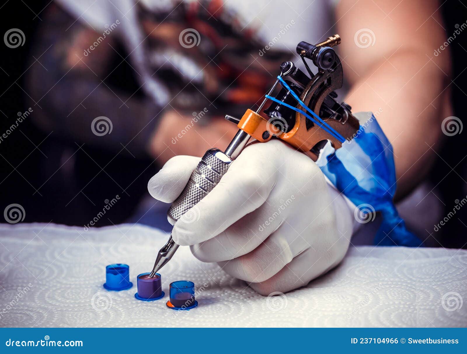Hand of a Tattooer, Holding a Tattoo Gun. Stock Photo - Image of client ...