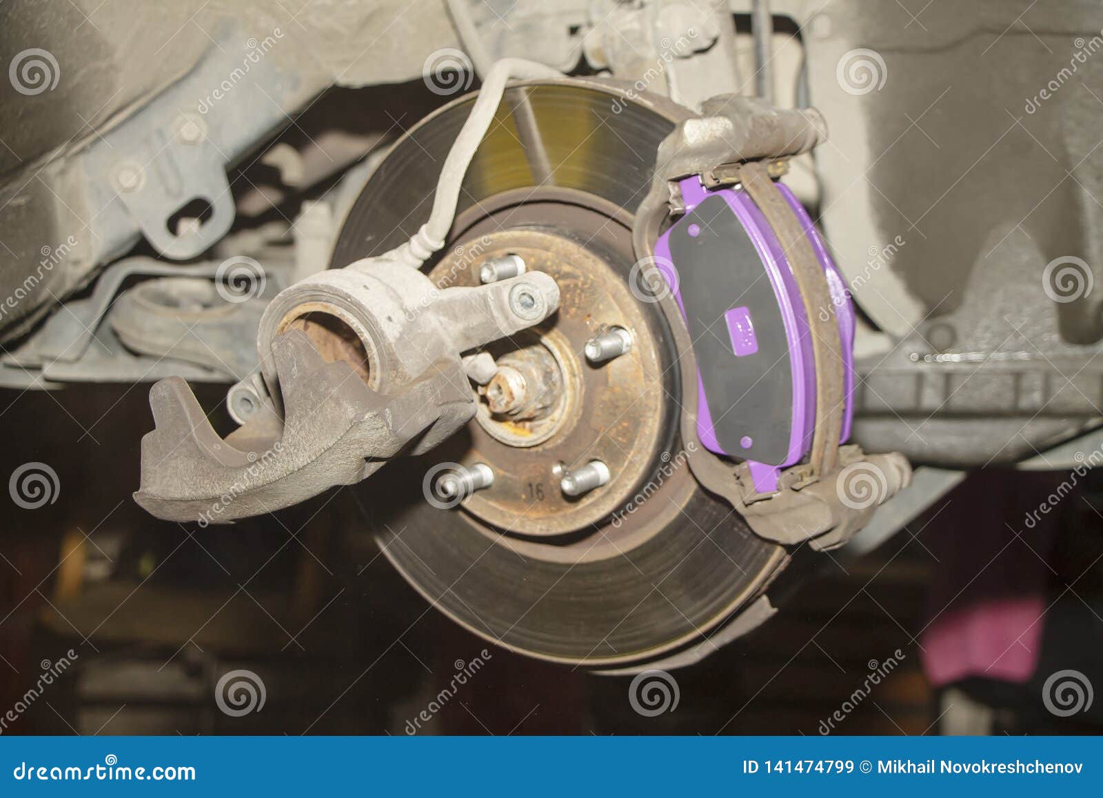 A Hand Technical Specialist Repairing the Brake System of the Modern