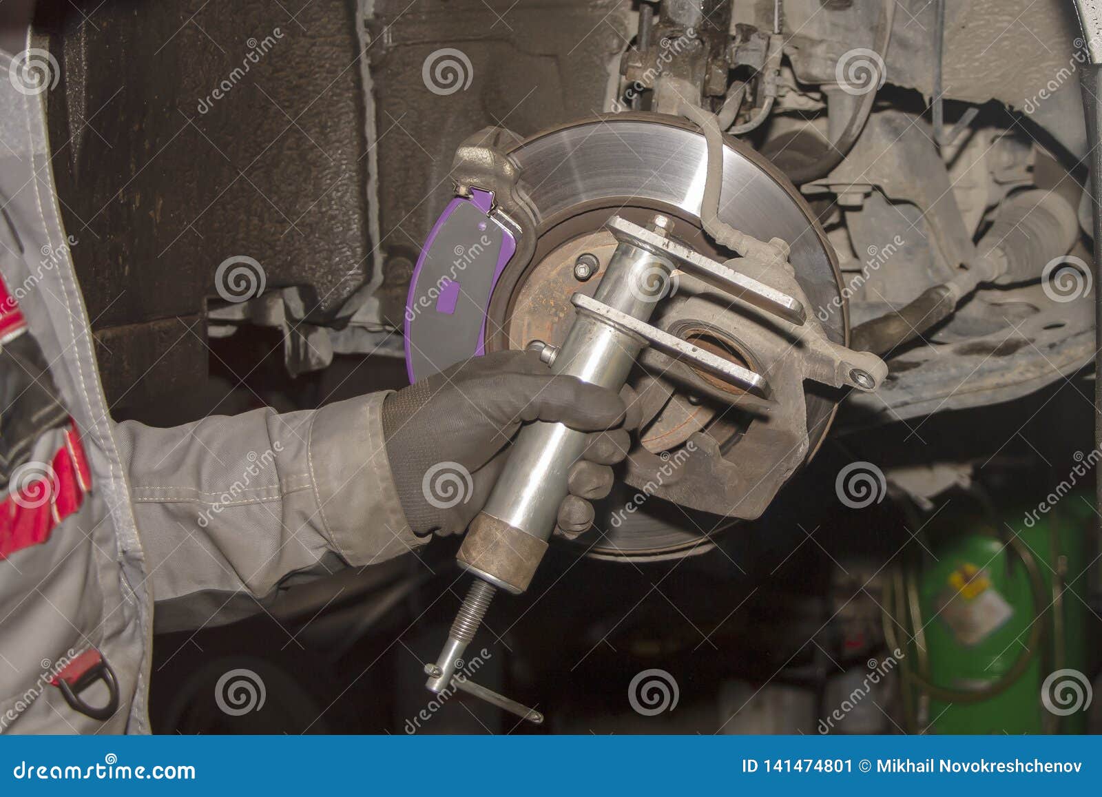 A Hand Technical Specialist Repairing the Brake System of the Modern