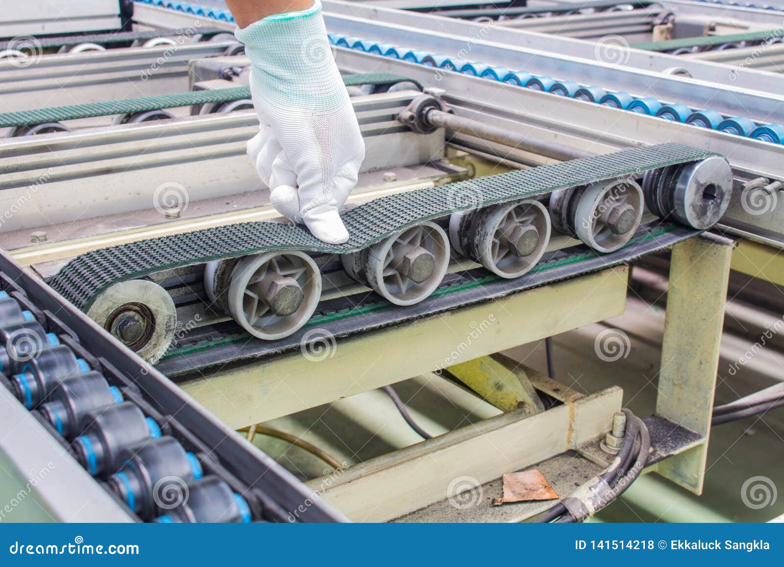 The Hand of Technician Checking Strength and Tension of Conveyor Belt