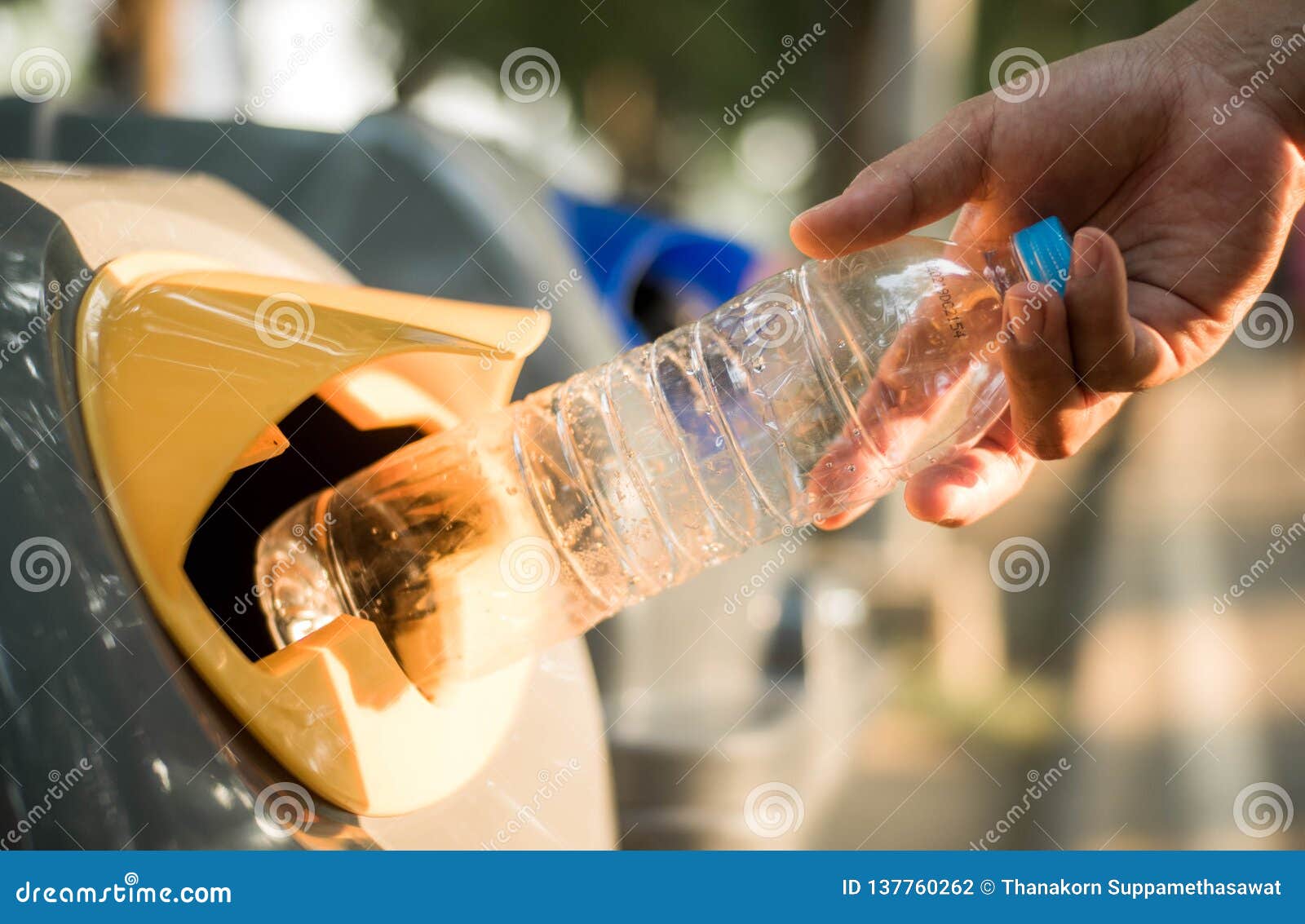 Hand Throwing Plastic Bottle in Recycling Bin, Global Warming Stock