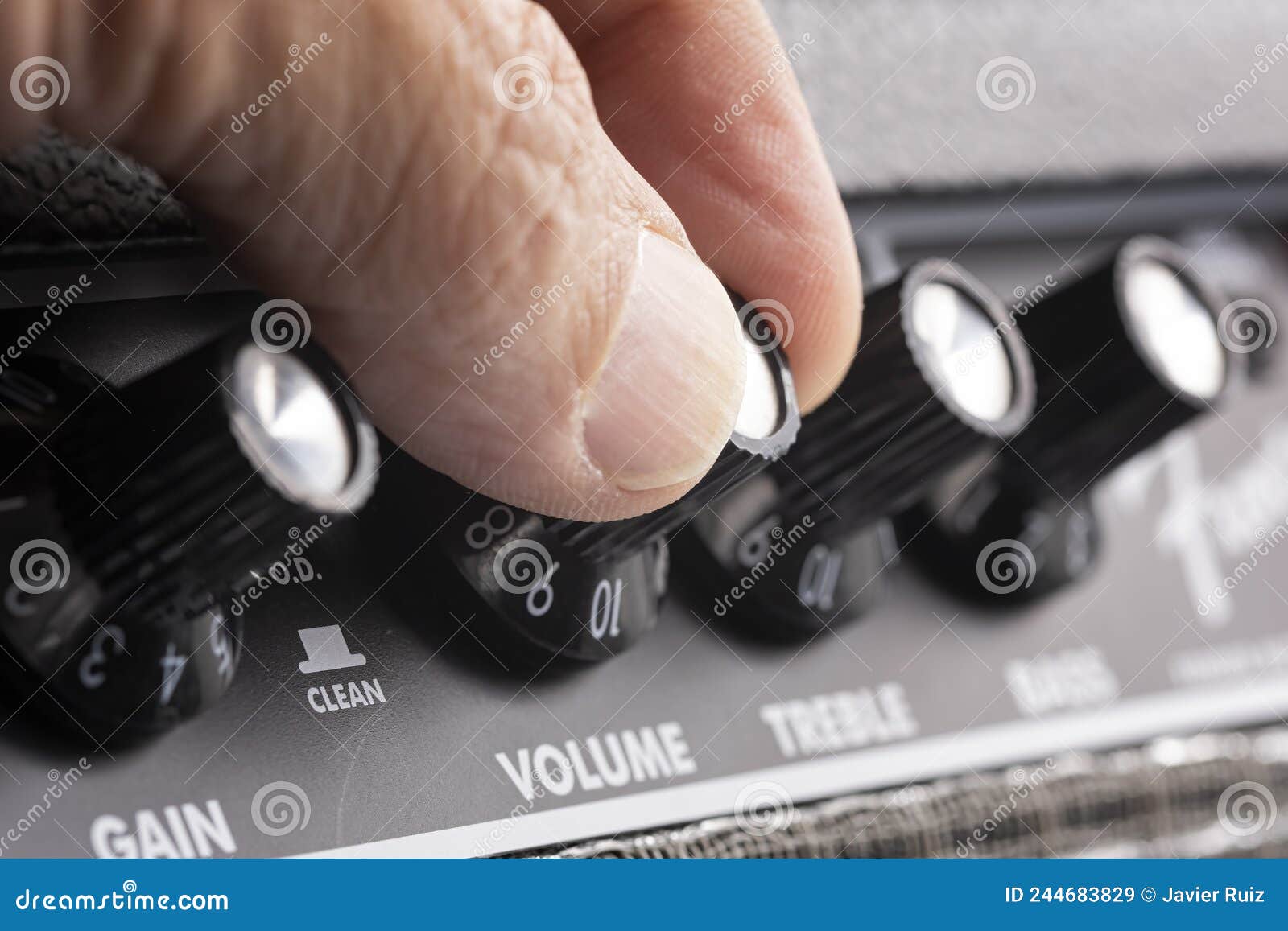 Hand Turning Up the Volume of a Guitar Amplifier, Treble and Bass