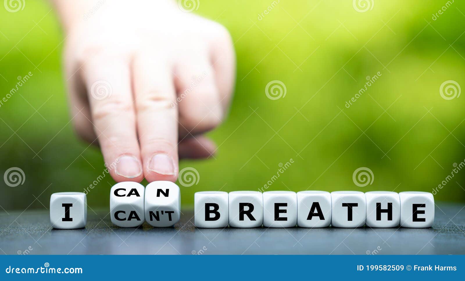 hand turns dice and changes the expression `i can`t breathe` to `i can breathe`.