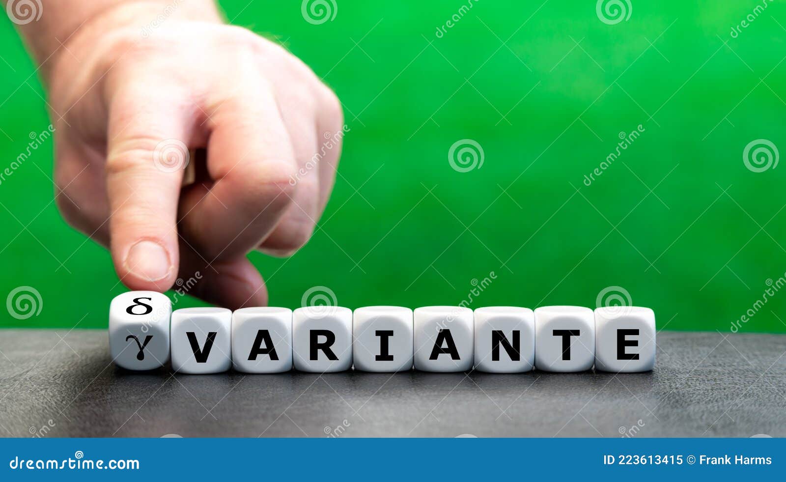 hand turns dice and changes the german expression `gamma variante` gamma variant to `delta variante` delta variant.