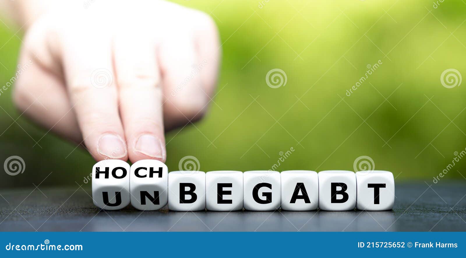 hand turns dice and changes the german expression `unbegabt` unskilled to `hochbegabt` highly sklilled.