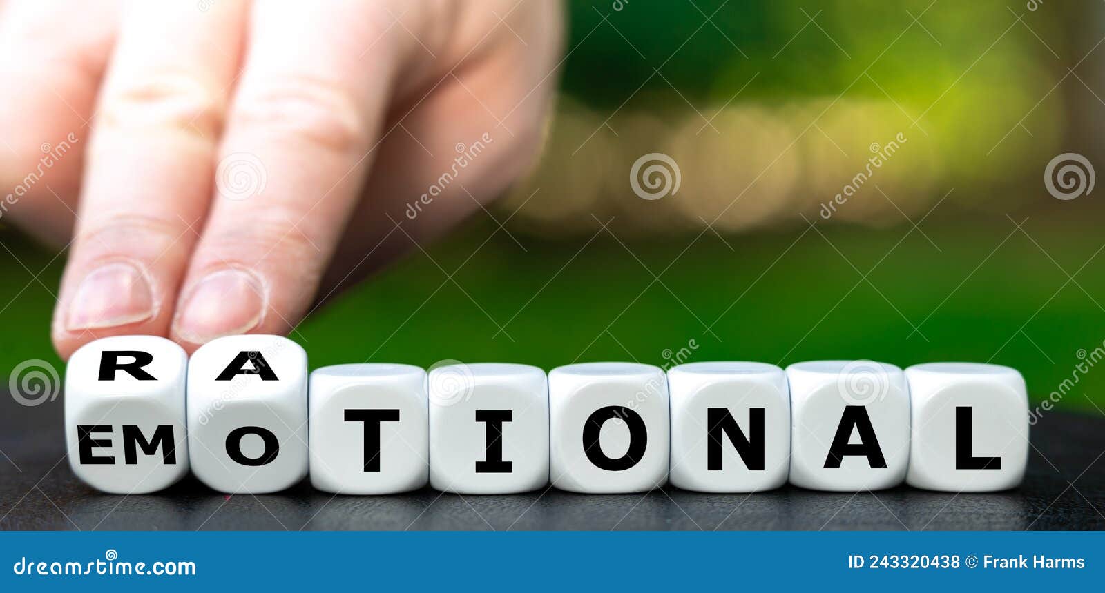 hand turns dice and changes the word emotional to rational