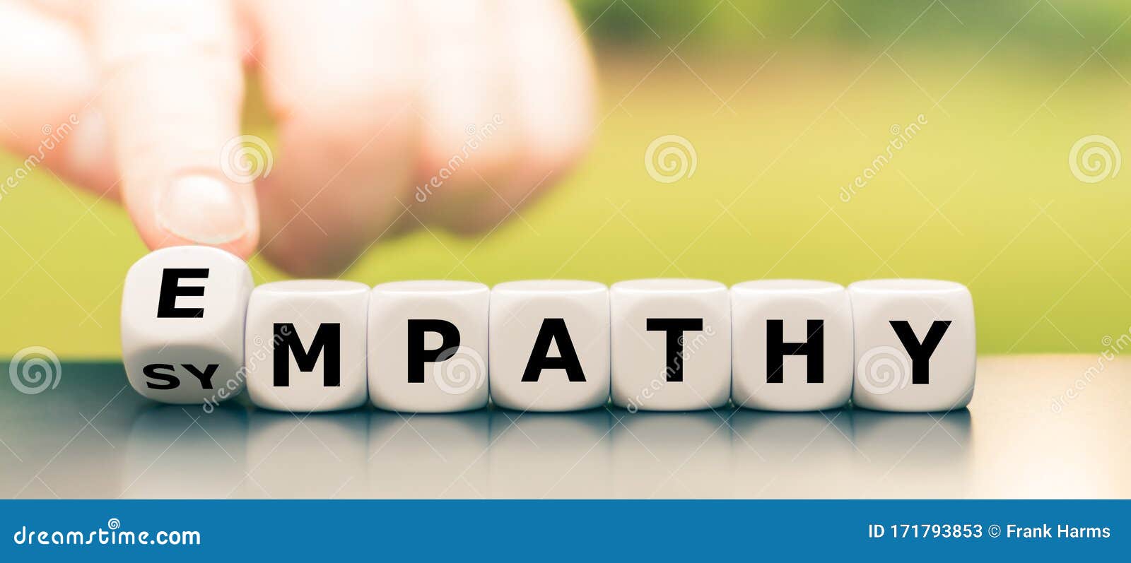 hand turns dice and changes the word `sympathy` to `empathy`.
