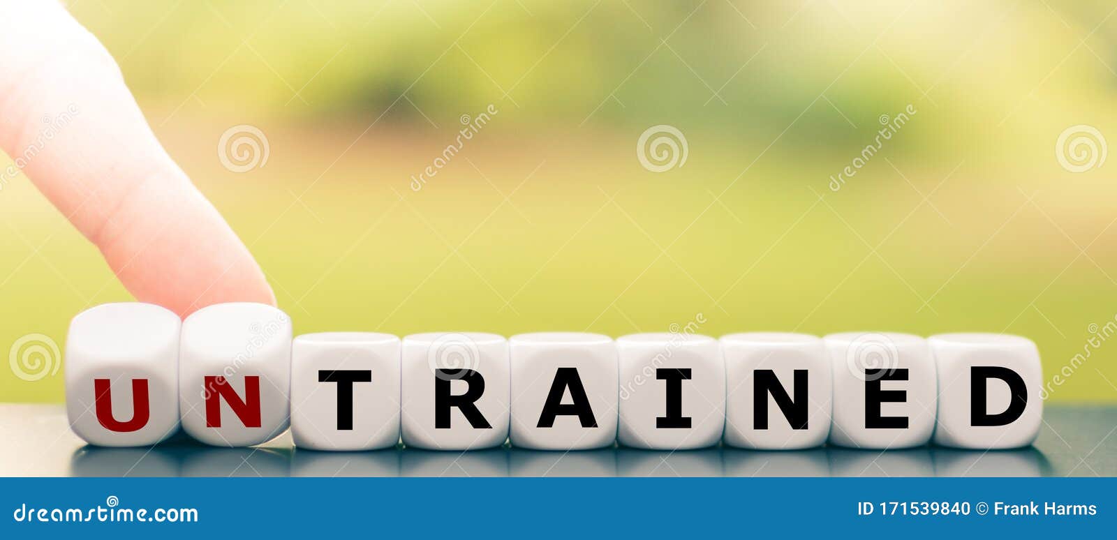 hand turns dice and changes the word `untrained` to `trained`.