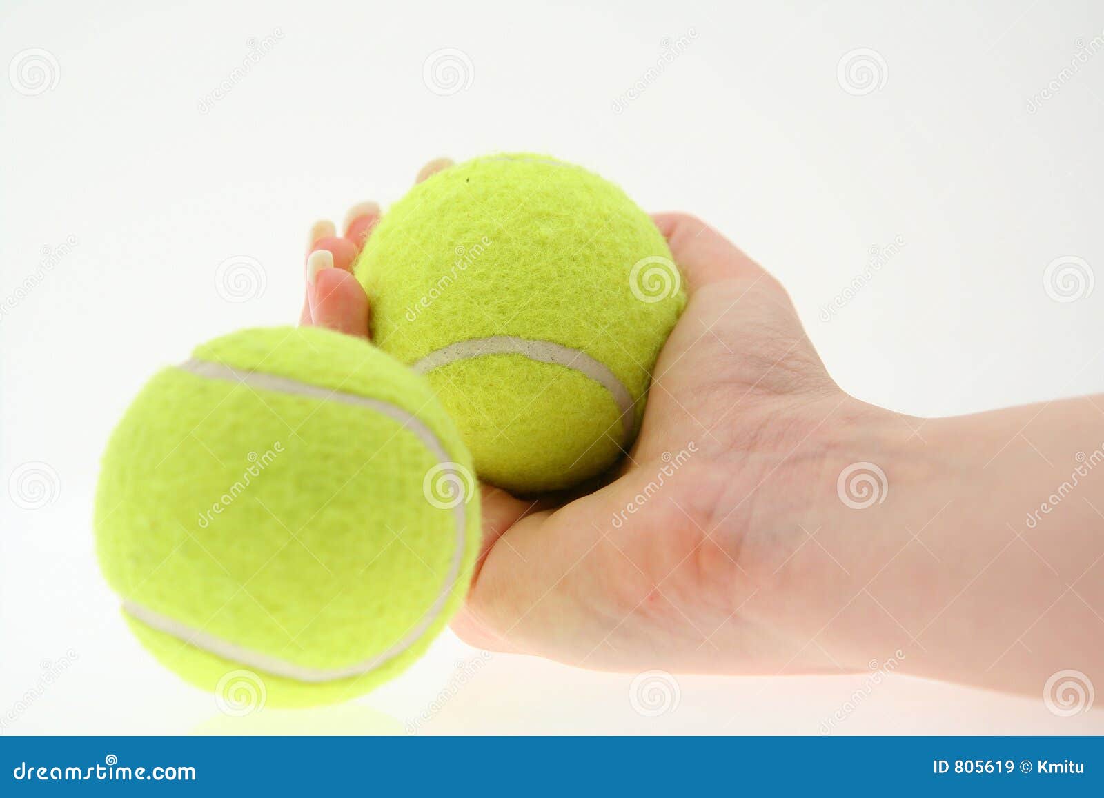 Hand with two tennis balls stock image. Image of green 805619